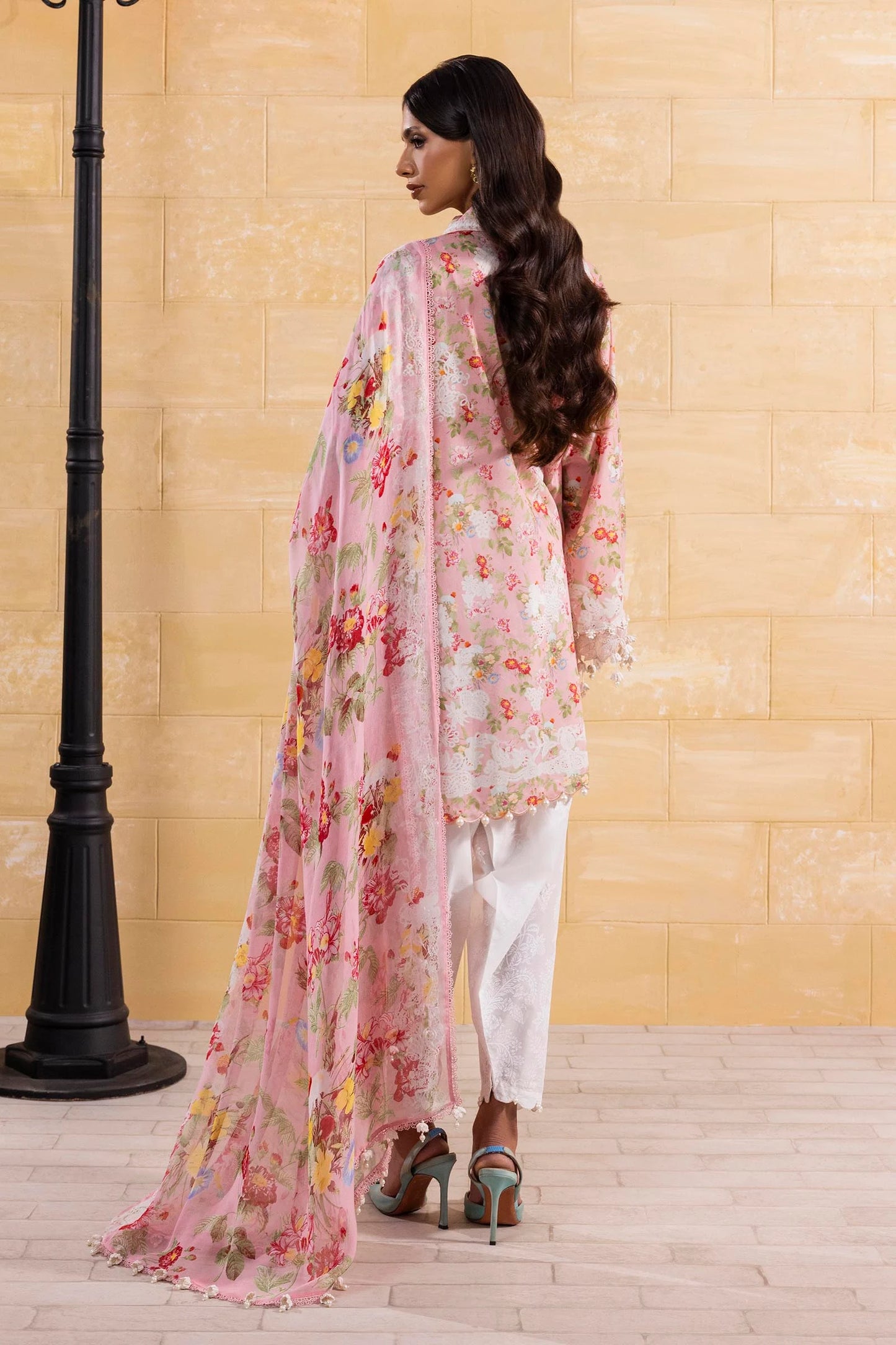Model wearing pink floral print dress with white lace details and printed dupatta from Sana Safinaz Muzlin Spring '25, Pakistani clothes online UK.