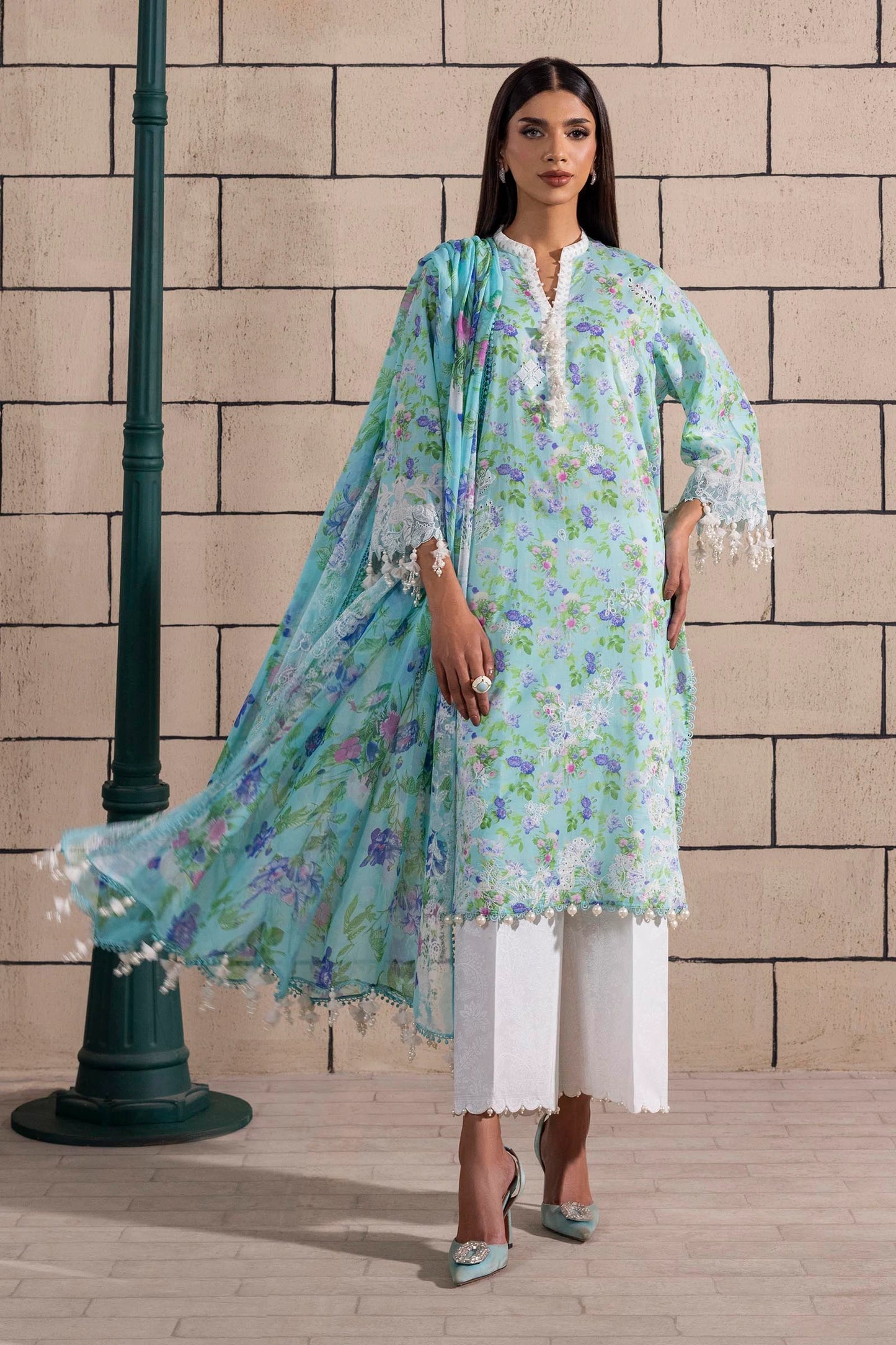 Model wearing aqua blue floral print dress with lace details and chiffon dupatta from Sana Safinaz Muzlin Spring '25, Pakistani Luxury pret UK.