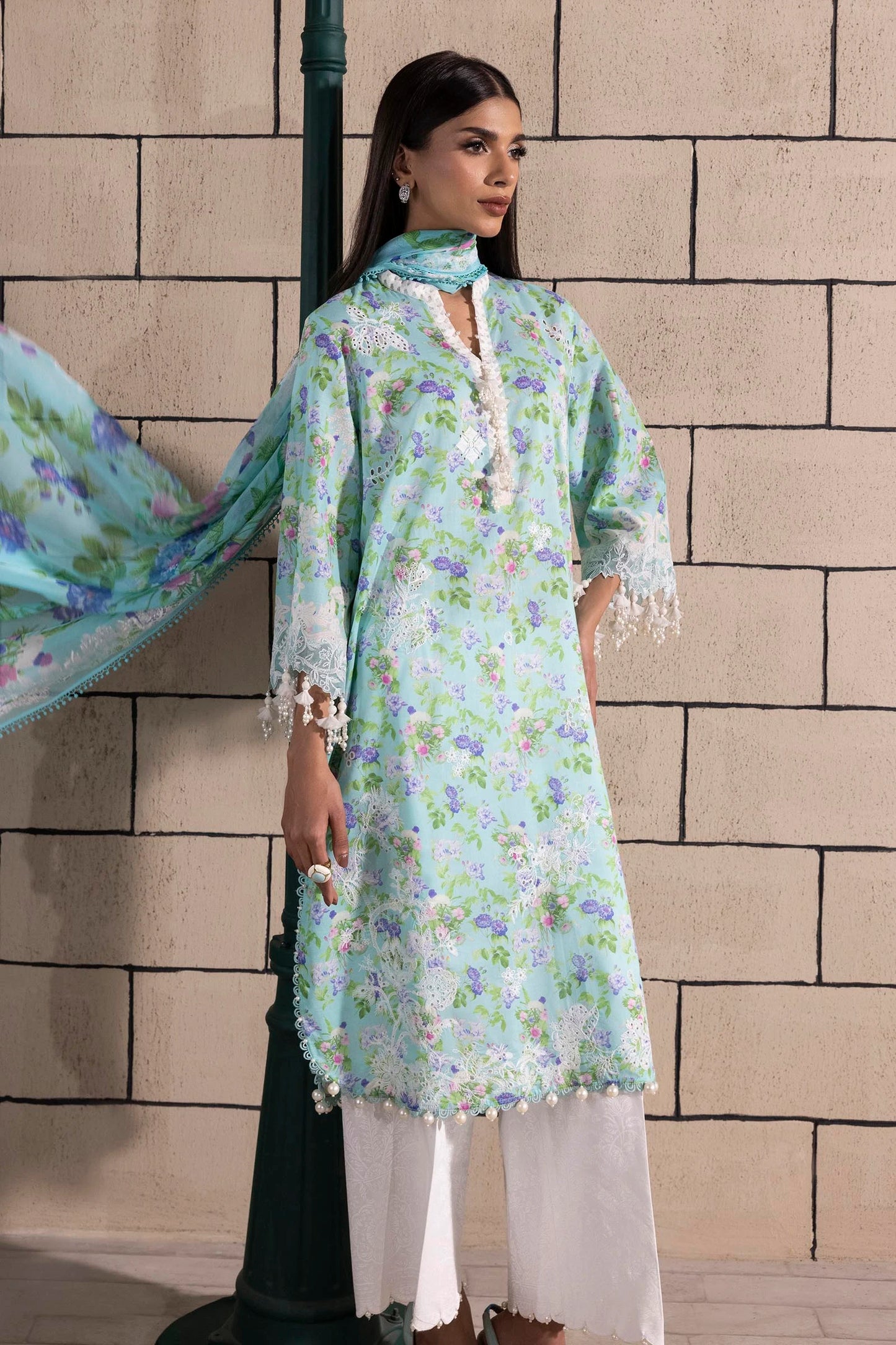 Model wearing aqua blue floral print dress with lace details and chiffon dupatta from Sana Safinaz Muzlin Spring '25, Pakistani Luxury pret UK.