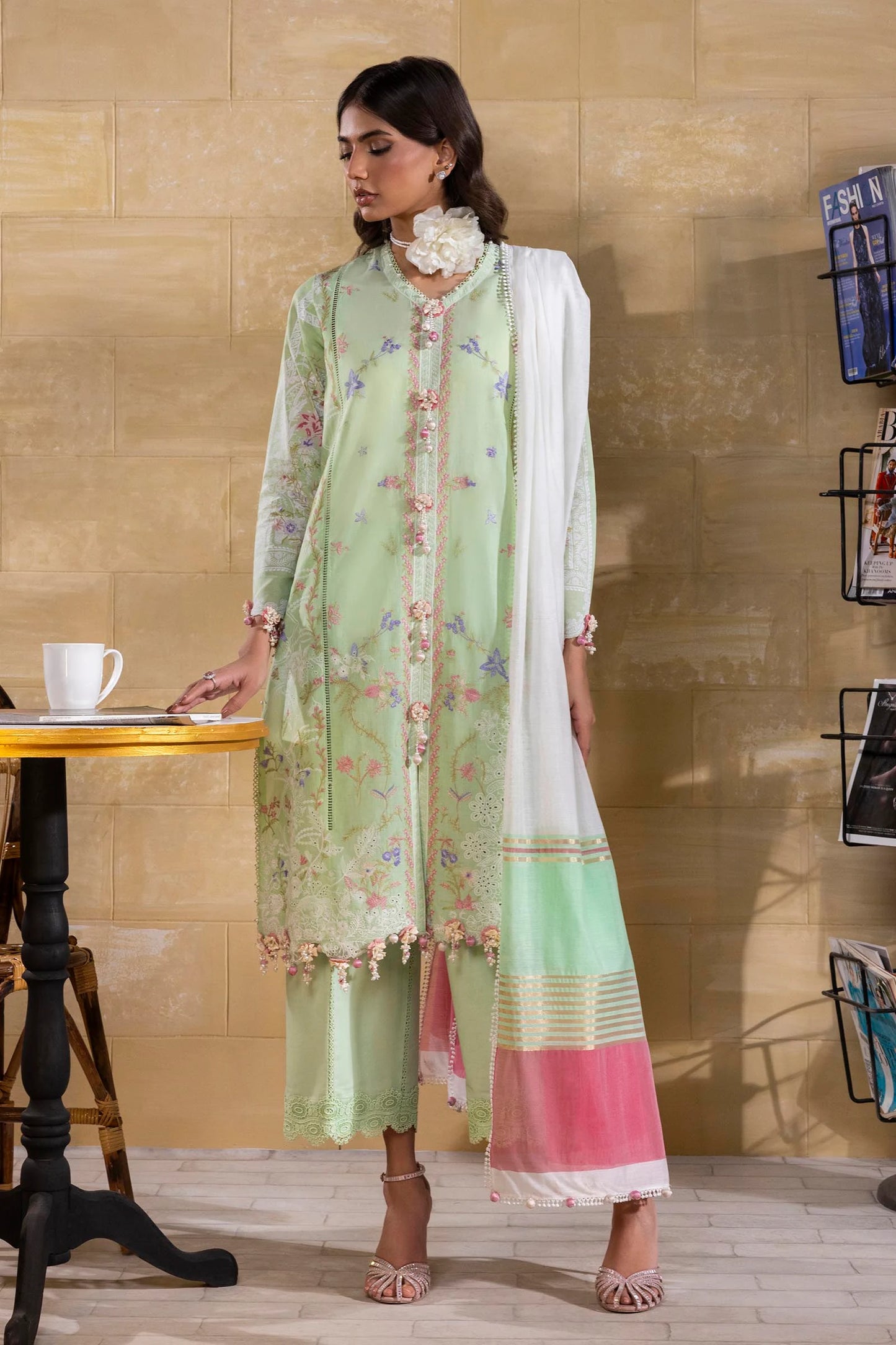 Model wearing pastel green embroidered dress with multicolor striped dupatta from Sana Safinaz Muzlin Spring '25, Pakistani Luxury pret UK.