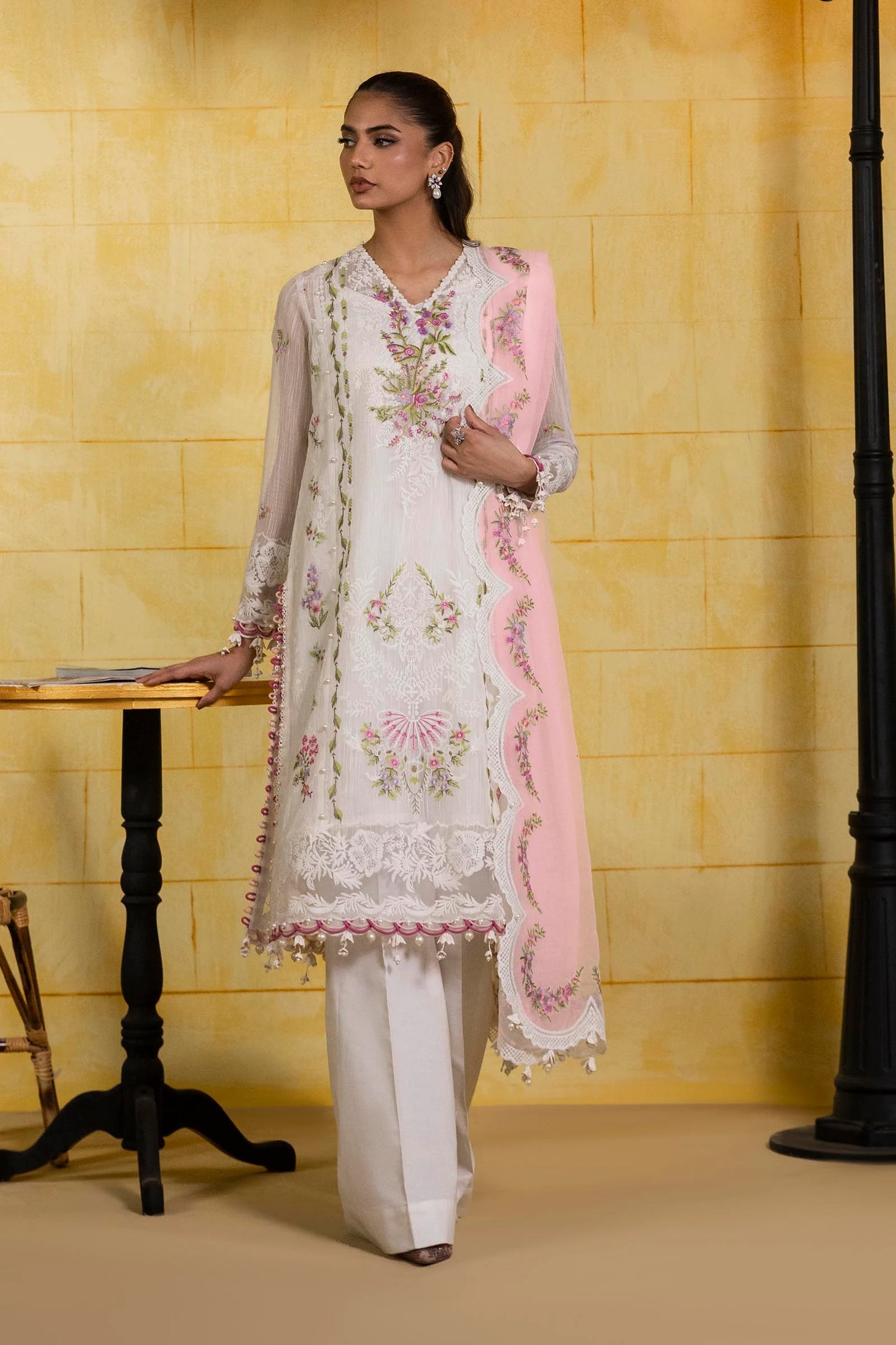 Model wearing ivory embroidered dress with pink scalloped dupatta from Sana Safinaz Muzlin Spring '25, Pakistani Luxury pret in UK.