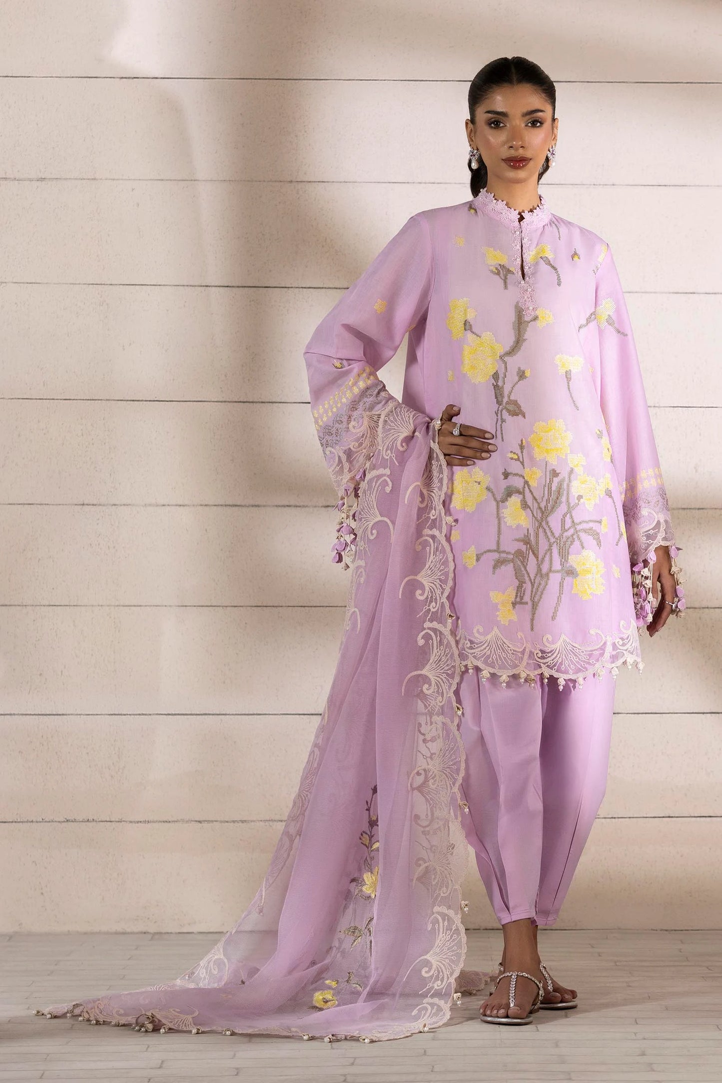 Model wearing lavender dress with yellow floral embroidery and matching dupatta from Sana Safinaz Muzlin Spring '25, Pakistani Luxury pret UK.