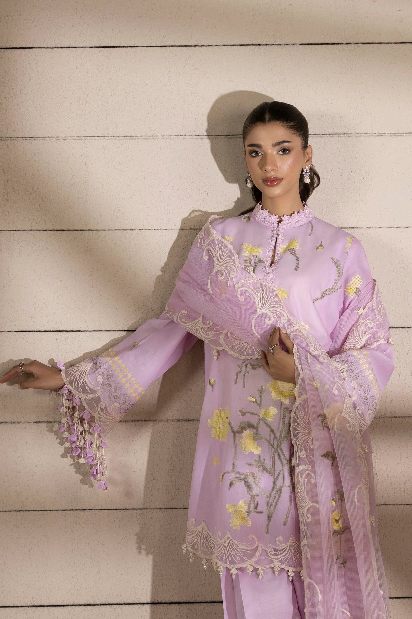 Model wearing lavender dress with yellow floral embroidery and matching dupatta from Sana Safinaz Muzlin Spring '25, Pakistani Luxury pret UK.