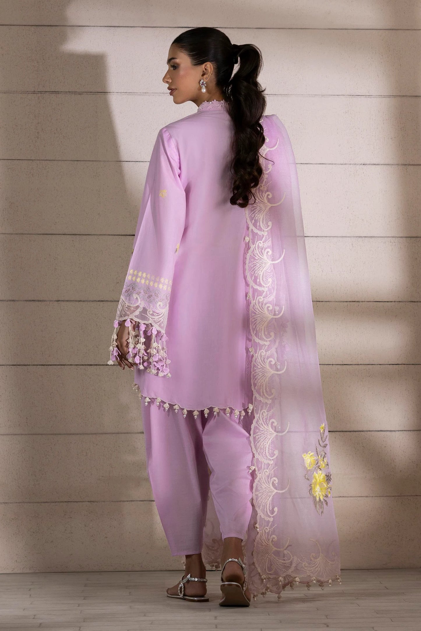 Model wearing lavender dress with yellow floral embroidery and matching dupatta from Sana Safinaz Muzlin Spring '25, Pakistani Luxury pret UK.