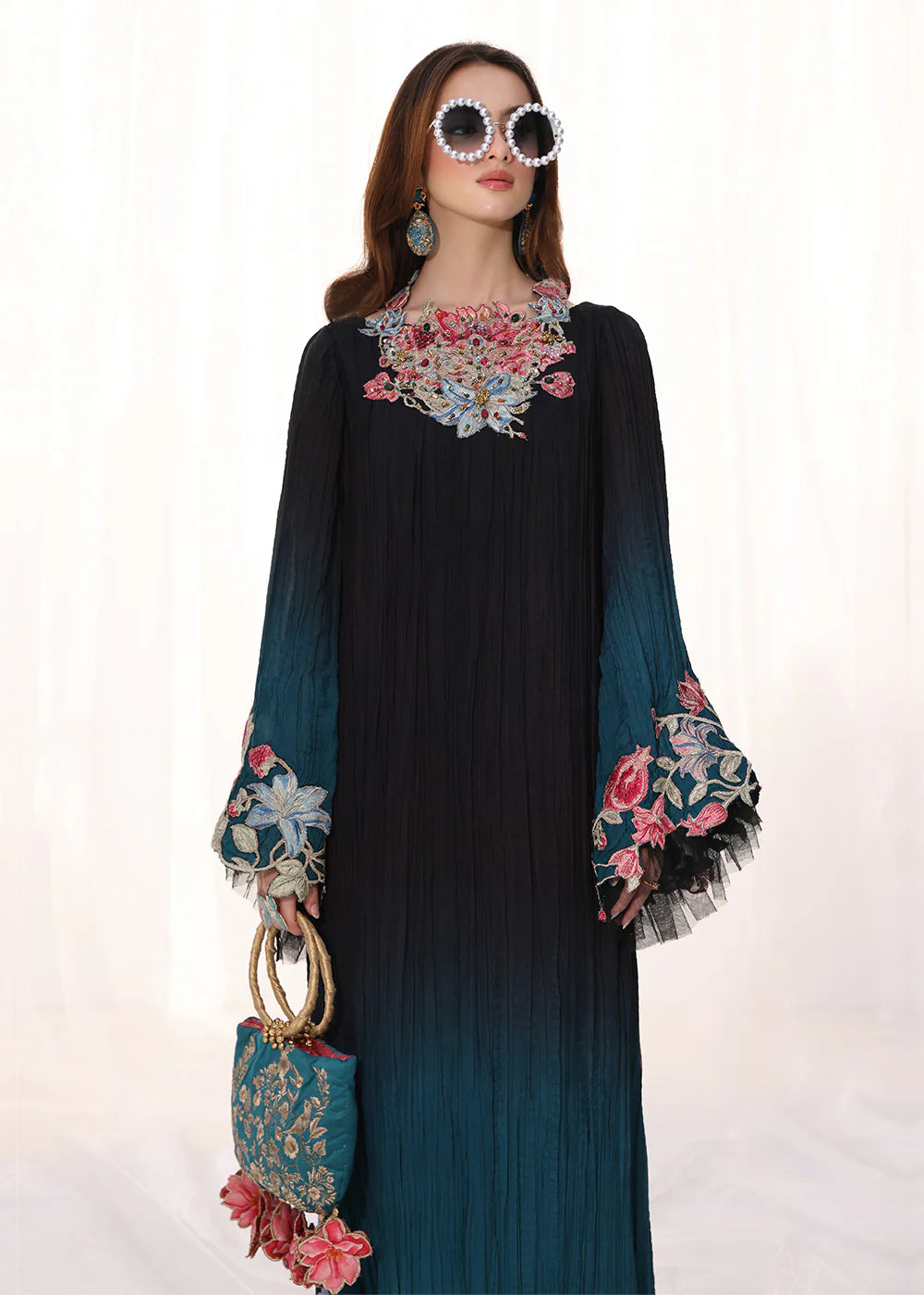Model wearing ombre black and teal embroidered pleated dress from Musferah Saad Moonlit Glam, Pakistani Luxury pret available online in UK.