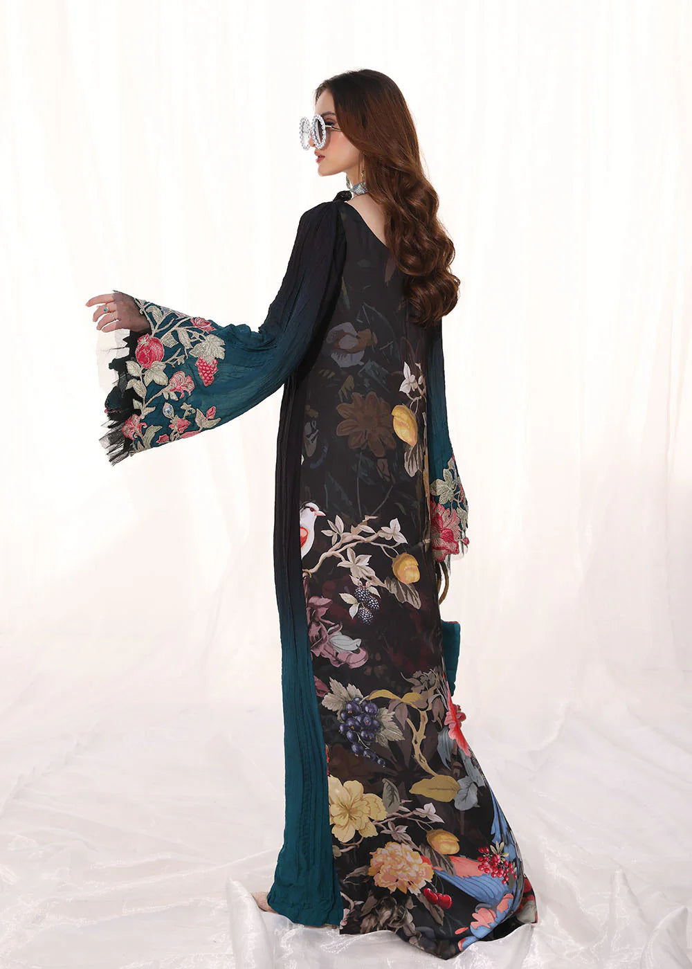 Model wearing ombre black and teal embroidered pleated dress from Musferah Saad Moonlit Glam, Pakistani Luxury pret available online in UK.
