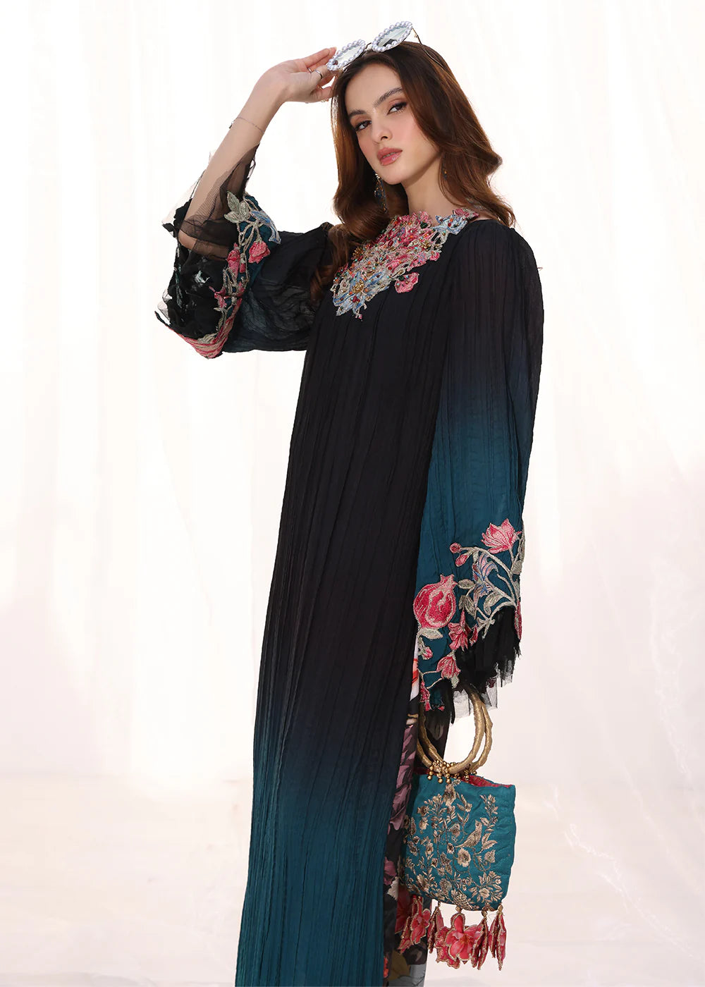 Model wearing ombre black and teal embroidered pleated dress from Musferah Saad Moonlit Glam, Pakistani Luxury pret available online in UK.