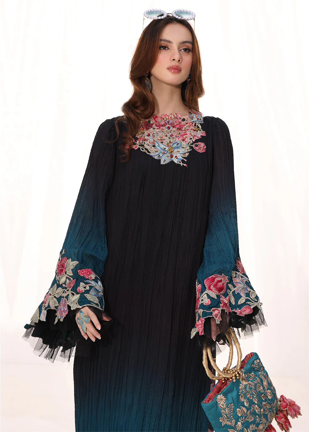 Model wearing ombre black and teal embroidered pleated dress from Musferah Saad Moonlit Glam, Pakistani Luxury pret available online in UK.