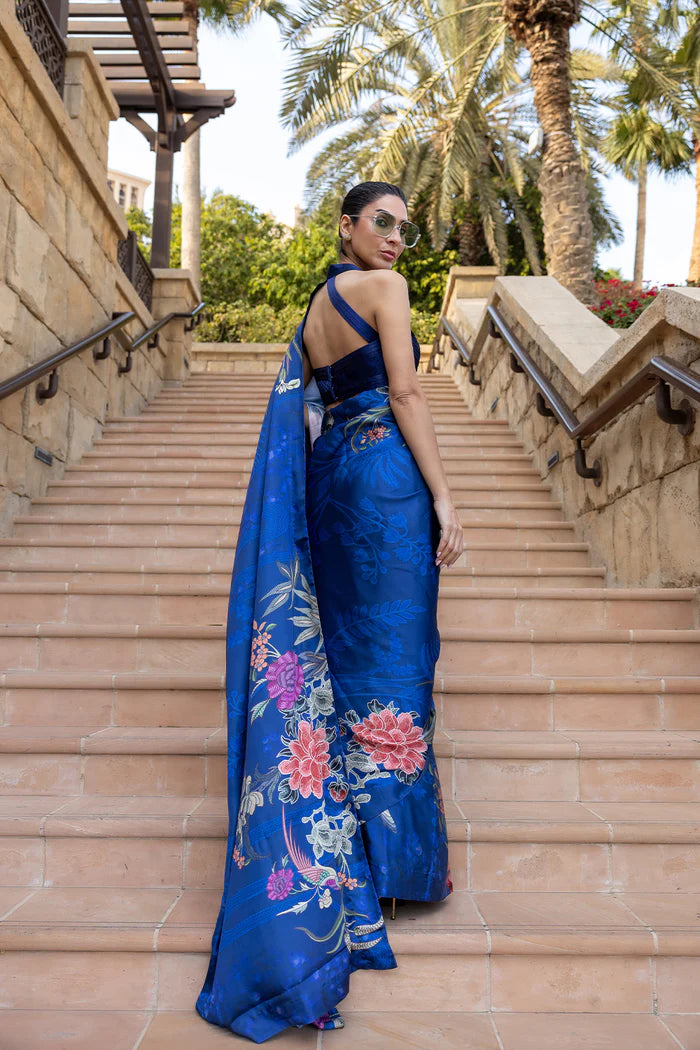Model wearing royal blue saree with multicolour floral and crane motifs from Saira Rizwan, Pakistani Luxury pret, Pakistani clothes online in UK.