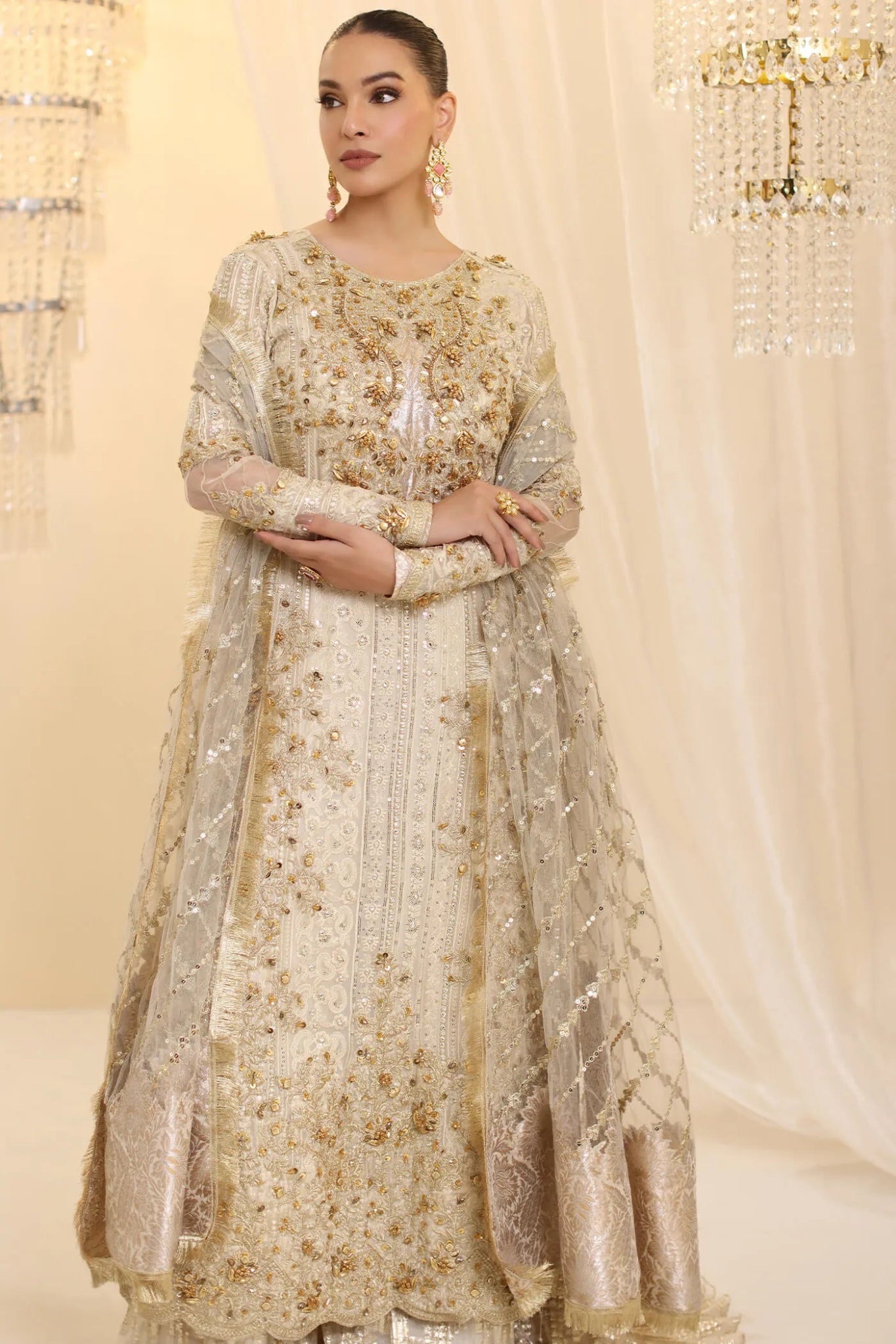 Model wearing Musferah Saad Ivory Empress dress in ivory from the Ethereal Dream Formals collection, ideal for Pakistani wedding clothes online in the UK.