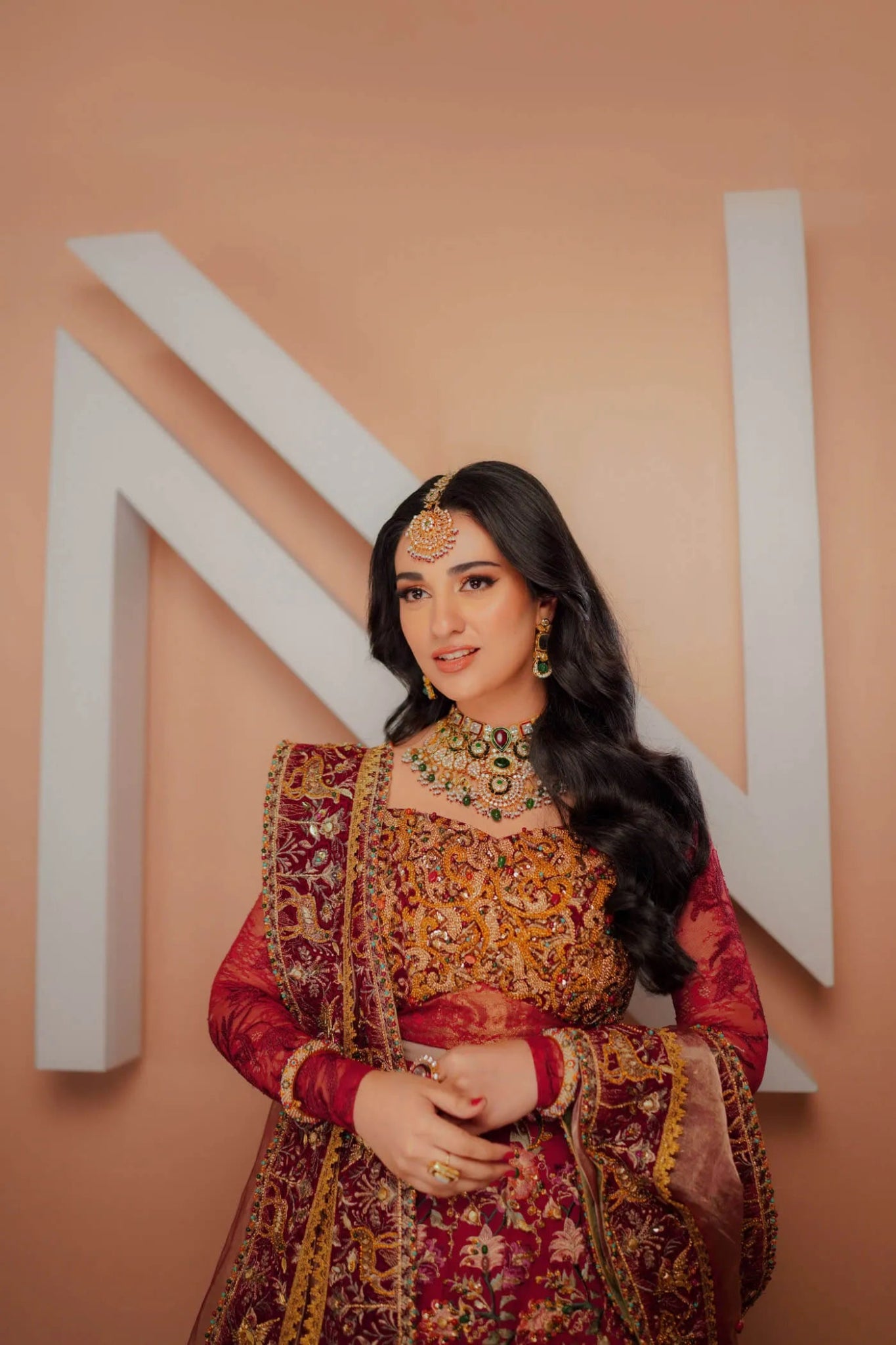 Model wearing a red ROYAL GODDESS dress from Musferah Saad's Luminous Love '24 collection, showcasing Pakistani clothes online in the UK.