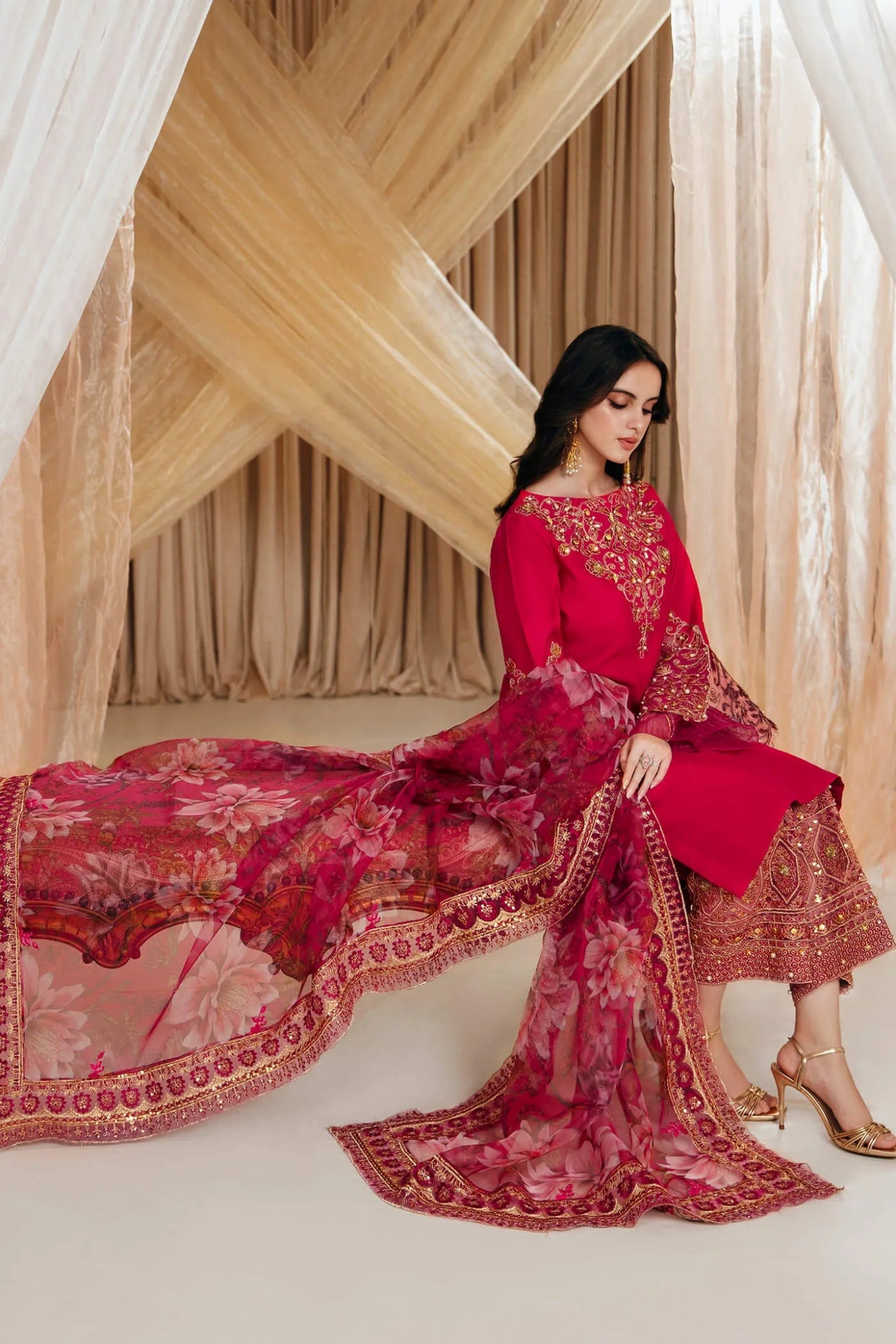 Model wearing a red RADIANT BLOOM dress from Musferah Saad's MYSTERE Eid collection '24, showcasing Pakistani clothes online in the UK.