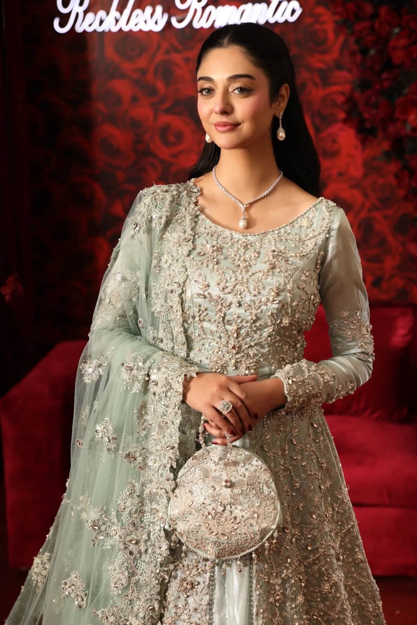 Model wearing Aqua Goddess from Musferah Saad's Reckless Romantic collection in a vibrant aqua shade. Pakistani clothes online in UK at Signature Labels.