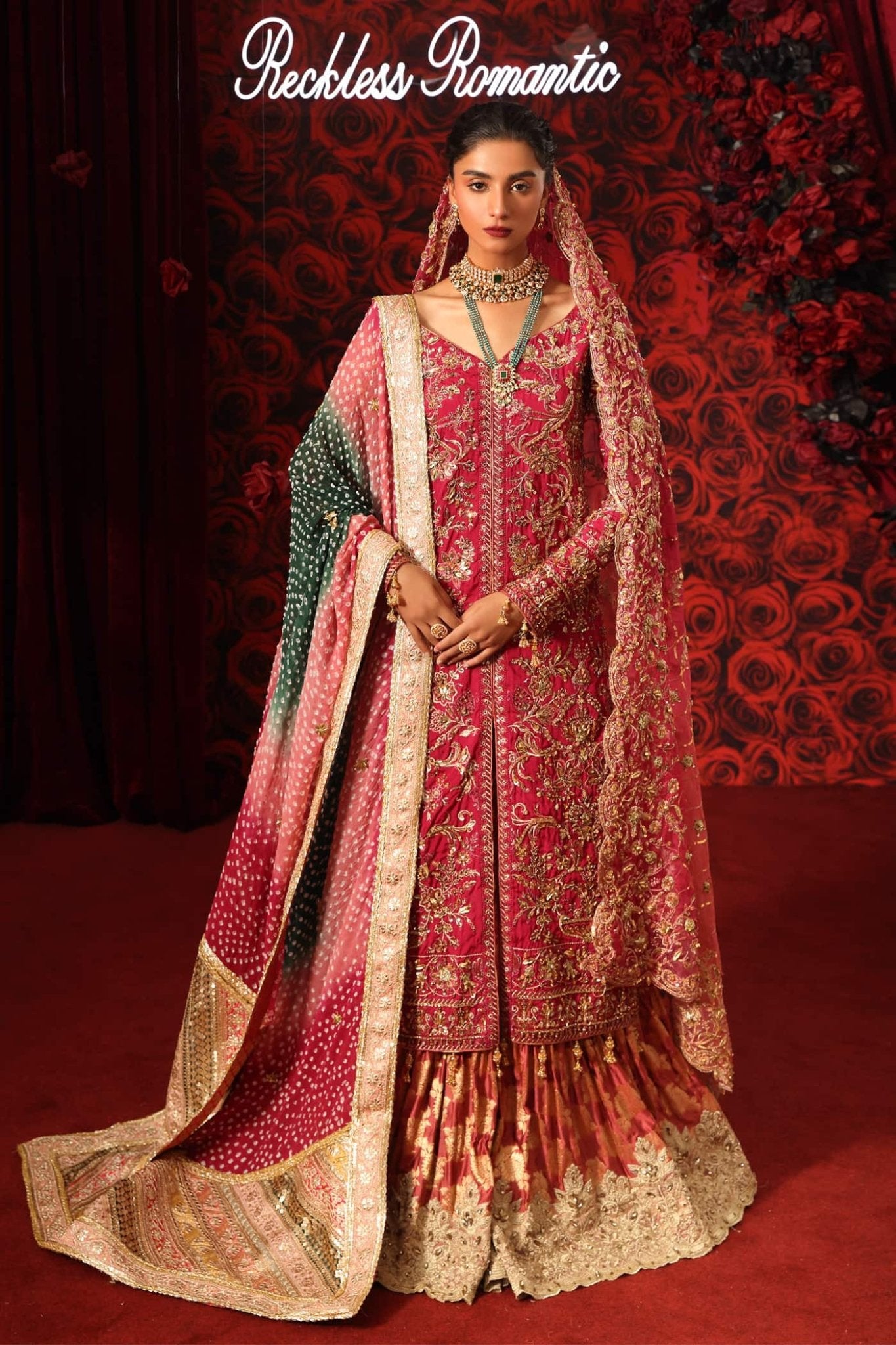 Model wearing Crimson Queen from Musferah Saad's Reckless Romantic in luxurious deep red tones. Pakistani clothes online in UK at Signature Labels