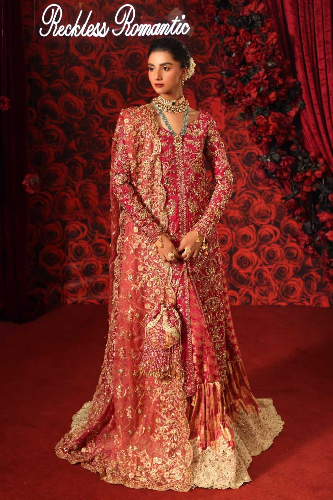 Model wearing Crimson Queen from Musferah Saad's Reckless Romantic in luxurious deep red tones. Pakistani clothes online in UK at Signature Labels