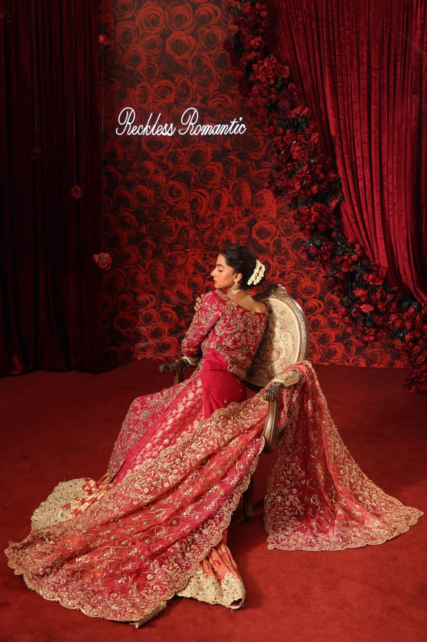 Model wearing Crimson Queen from Musferah Saad's Reckless Romantic in luxurious deep red tones. Pakistani clothes online in UK at Signature Labels