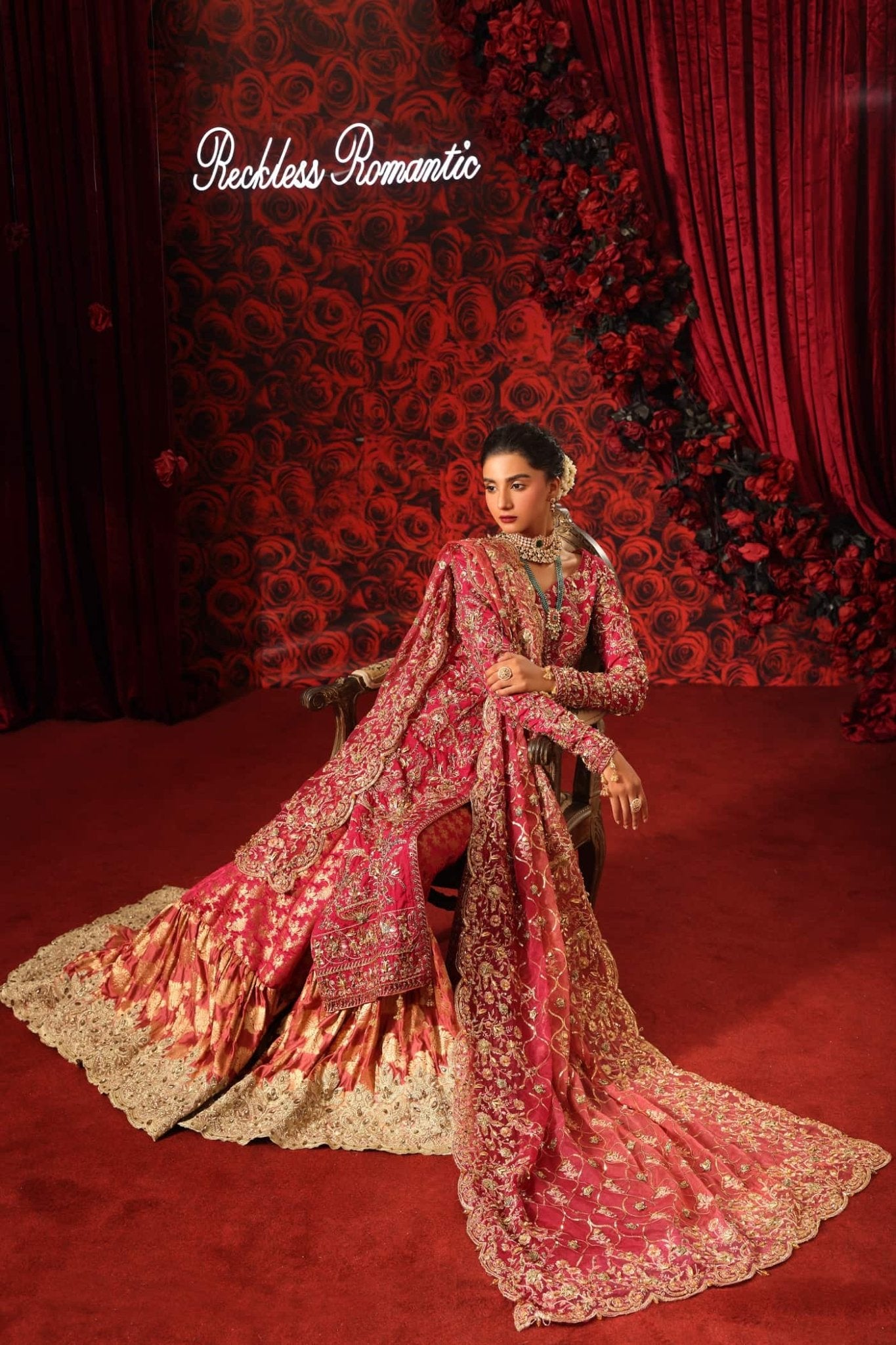 Model wearing Crimson Queen from Musferah Saad's Reckless Romantic in luxurious deep red tones. Pakistani clothes online in UK at Signature Labels