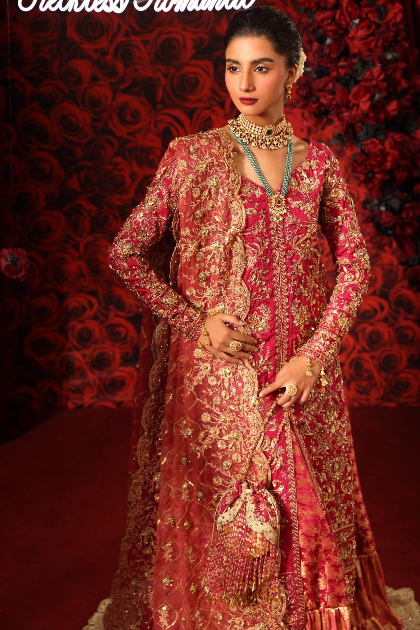 Model wearing Crimson Queen from Musferah Saad's Reckless Romantic in luxurious deep red tones. Pakistani clothes online in UK at Signature Labels