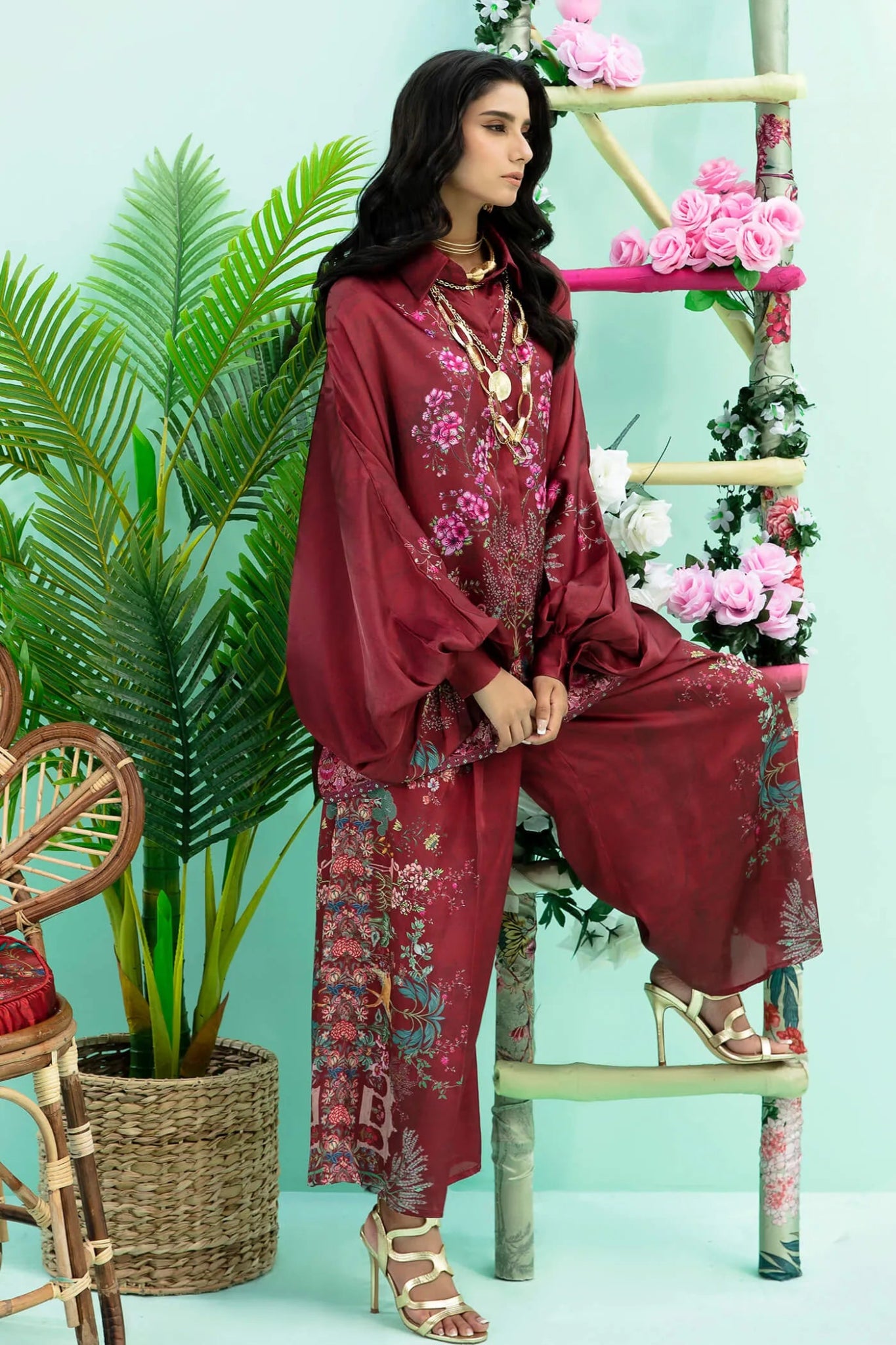 Model wearing maroon Floral Flare dress from Musferah Saad's Resort collection '24, showcasing Pakistani clothes online in the UK.