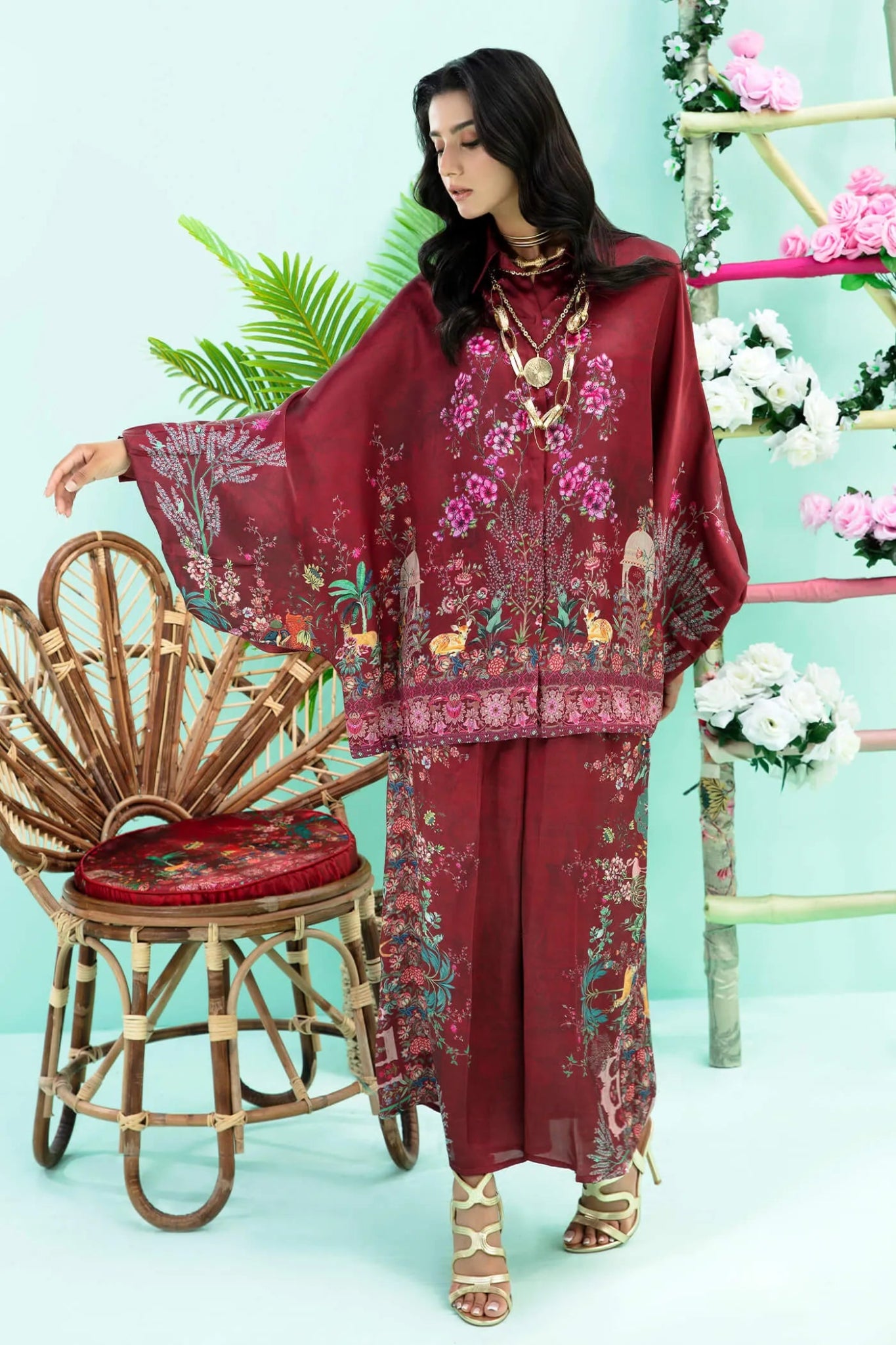 Model wearing maroon Floral Flare dress from Musferah Saad's Resort collection '24, showcasing Pakistani clothes online in the UK.
