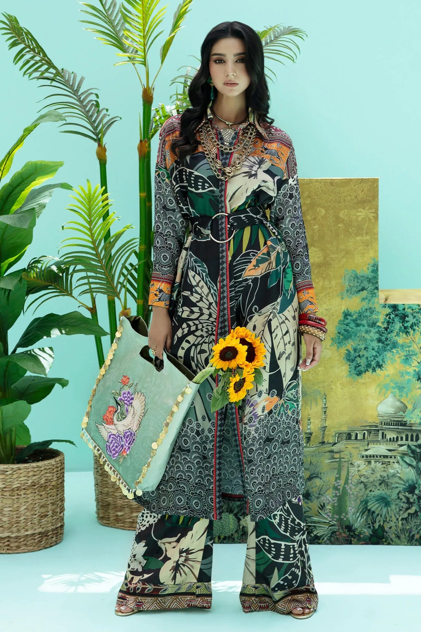 Model wearing a colorful fusion of black, rust, and green SAFARI SWAY dress from Musferah Saad's Resort collection '24, showcasing Pakistani clothes online in the UK.