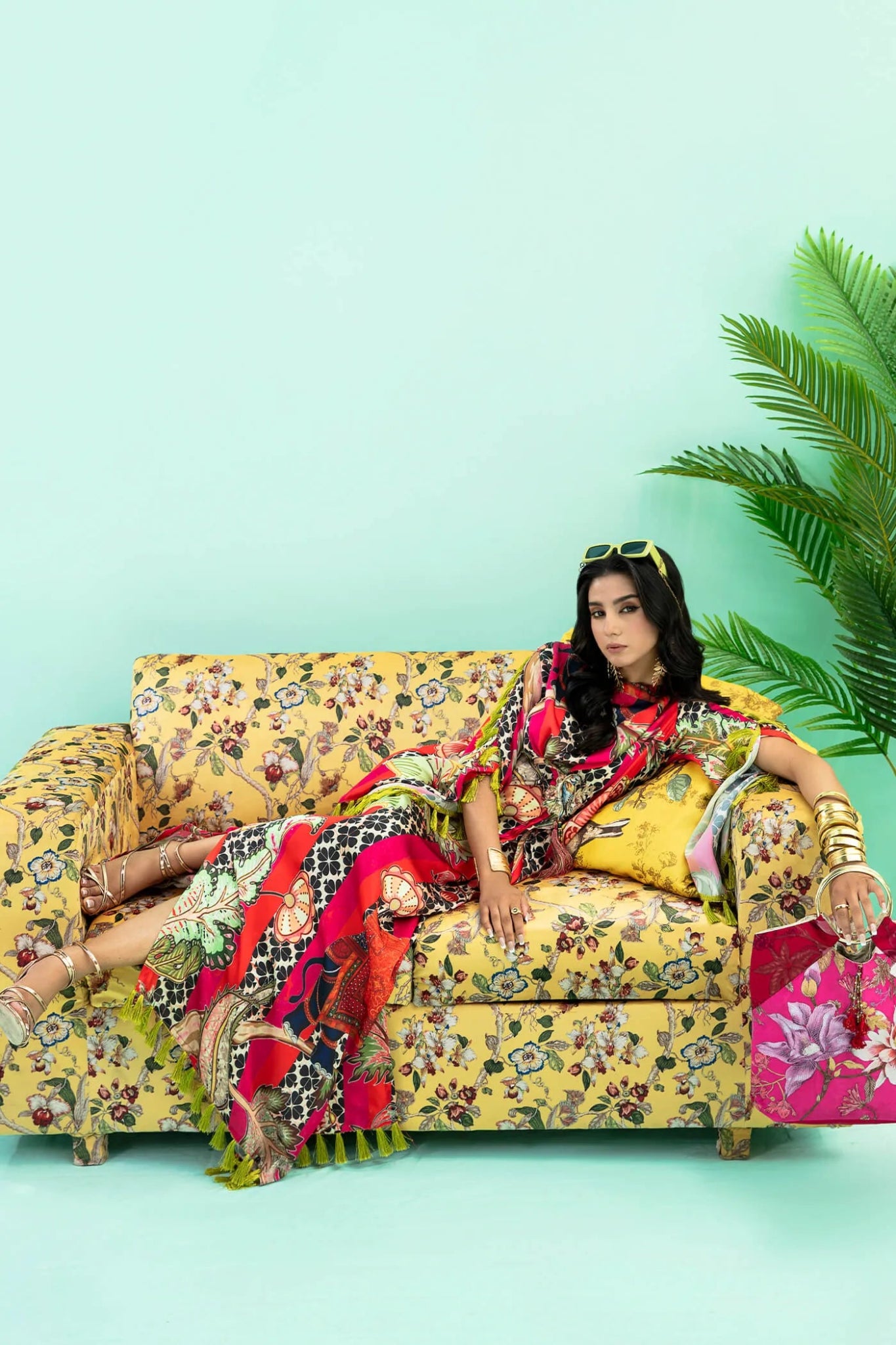 Model wearing a colorful fusion of pink, red, and sage TROPICANO dress from Musferah Saad's Resort collection '24, showcasing Pakistani clothes online in the UK.