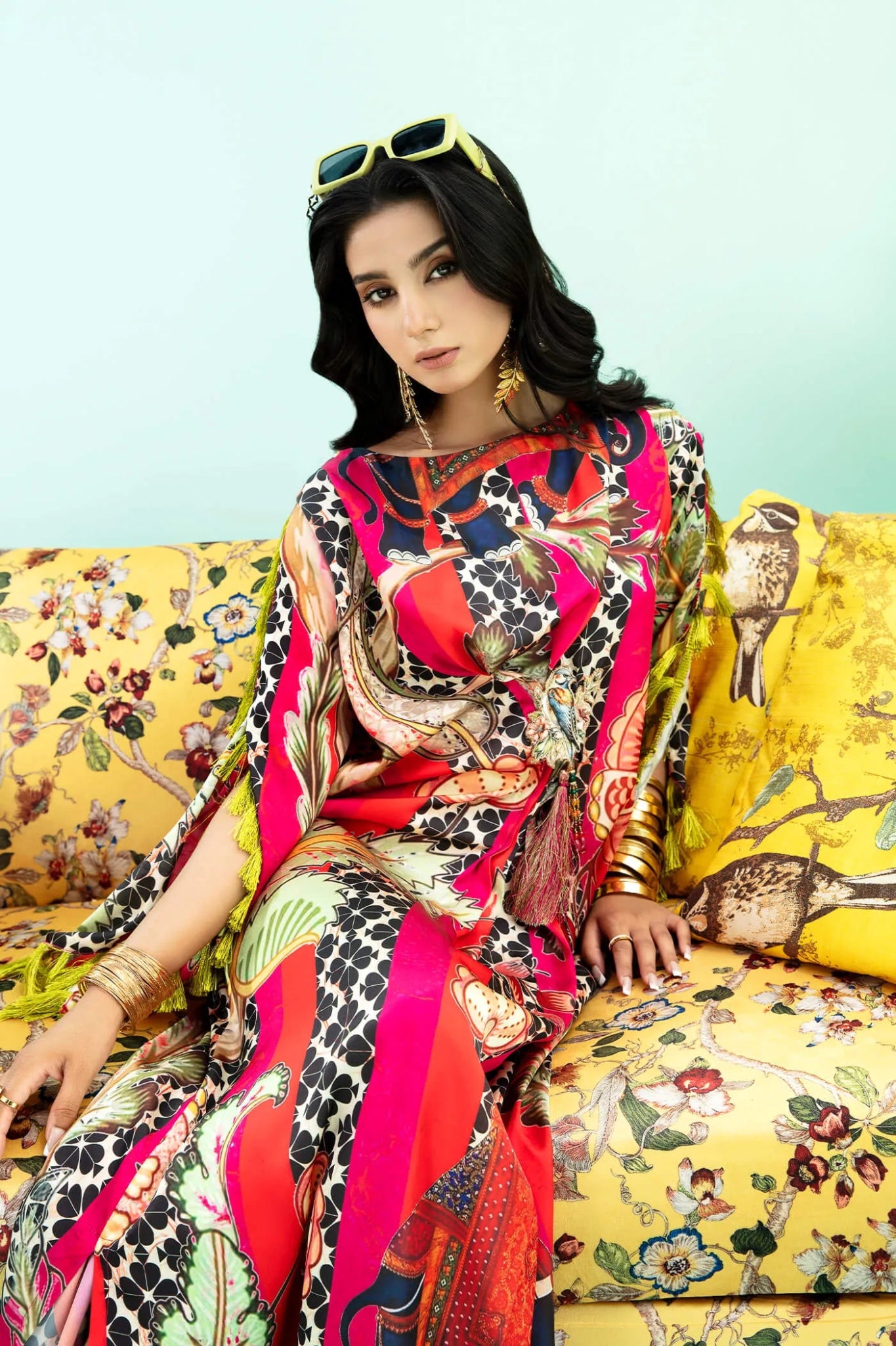 Model wearing a colorful fusion of pink, red, and sage TROPICANO dress from Musferah Saad's Resort collection '24, showcasing Pakistani clothes online in the UK.