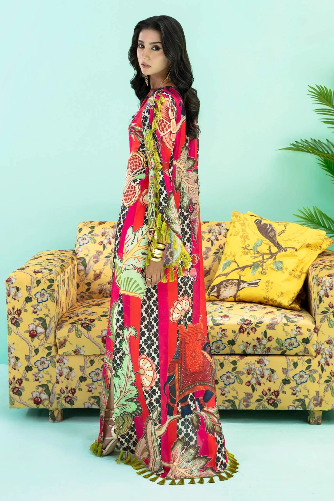 Model wearing a colorful fusion of pink, red, and sage TROPICANO dress from Musferah Saad's Resort collection '24, showcasing Pakistani clothes online in the UK.