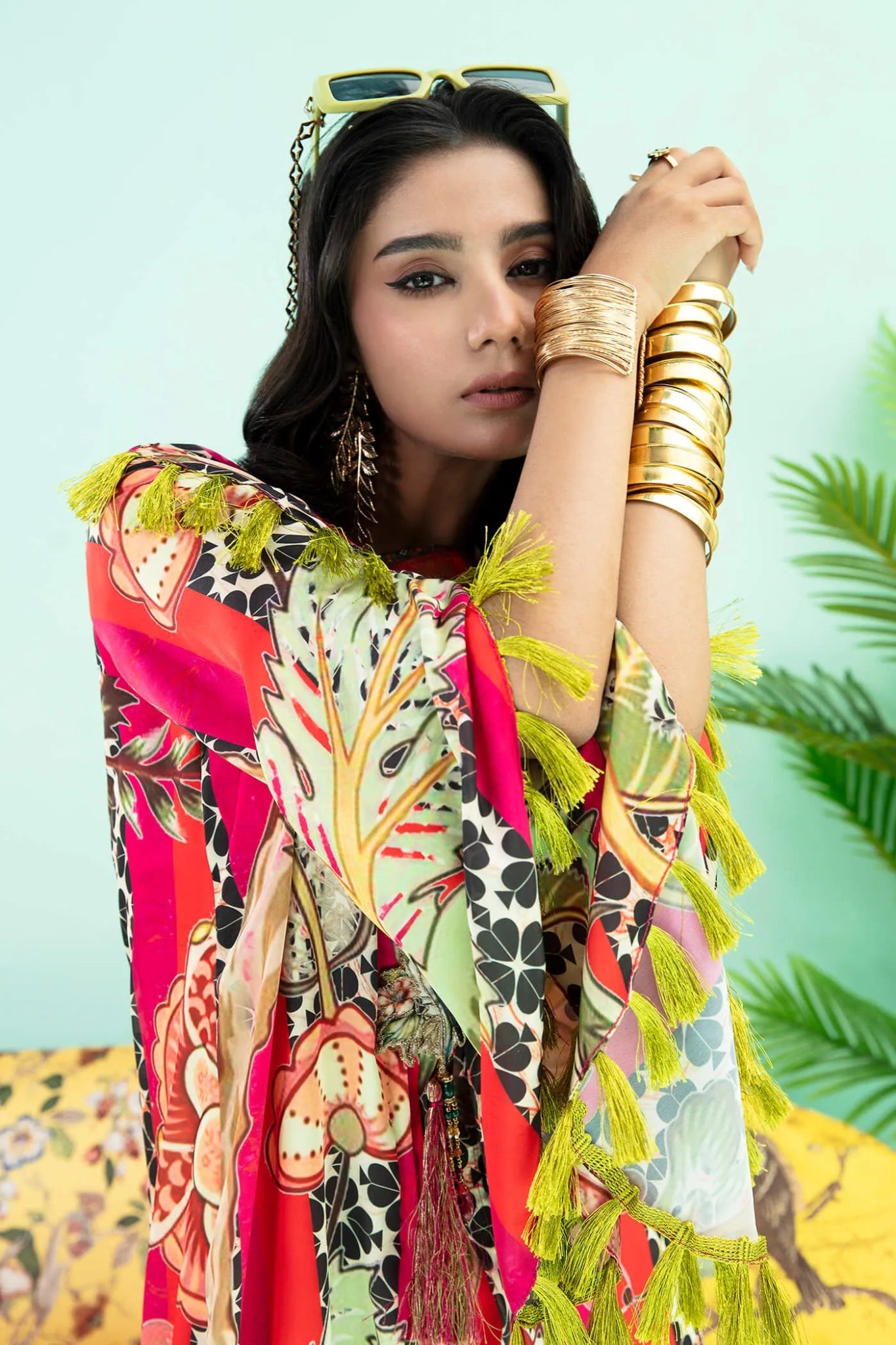 Model wearing a colorful fusion of pink, red, and sage TROPICANO dress from Musferah Saad's Resort collection '24, showcasing Pakistani clothes online in the UK.