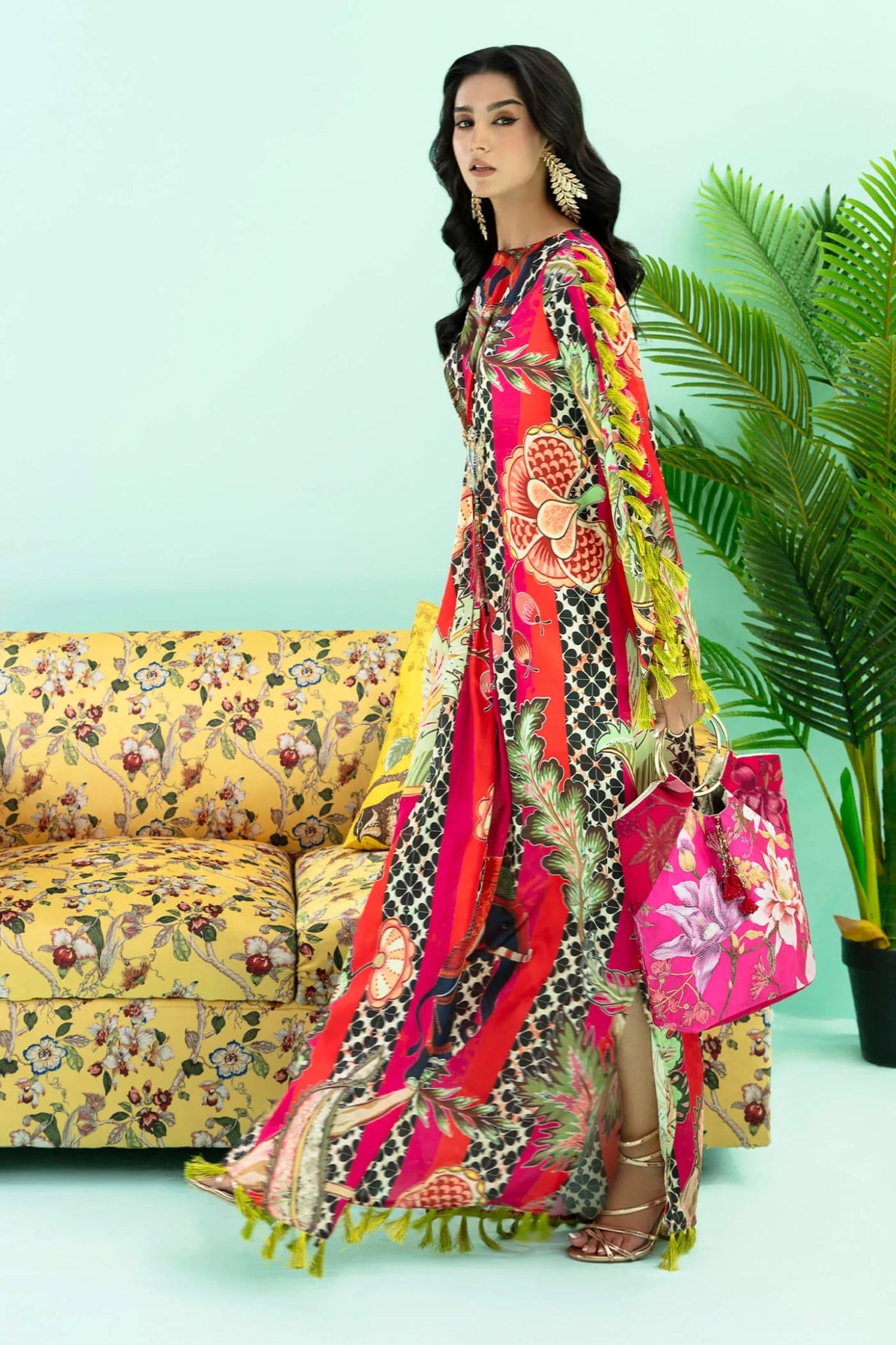 Model wearing a colorful fusion of pink, red, and sage TROPICANO dress from Musferah Saad's Resort collection '24, showcasing Pakistani clothes online in the UK.