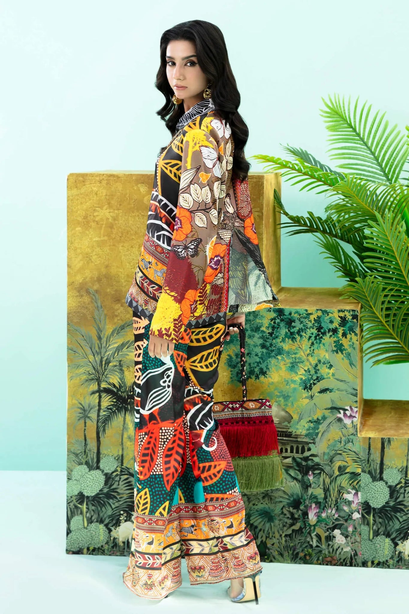 Model wearing colorful Wildflower dress from Musferah Saad's Resort collection '24, showcasing Pakistani clothes online in the UK.