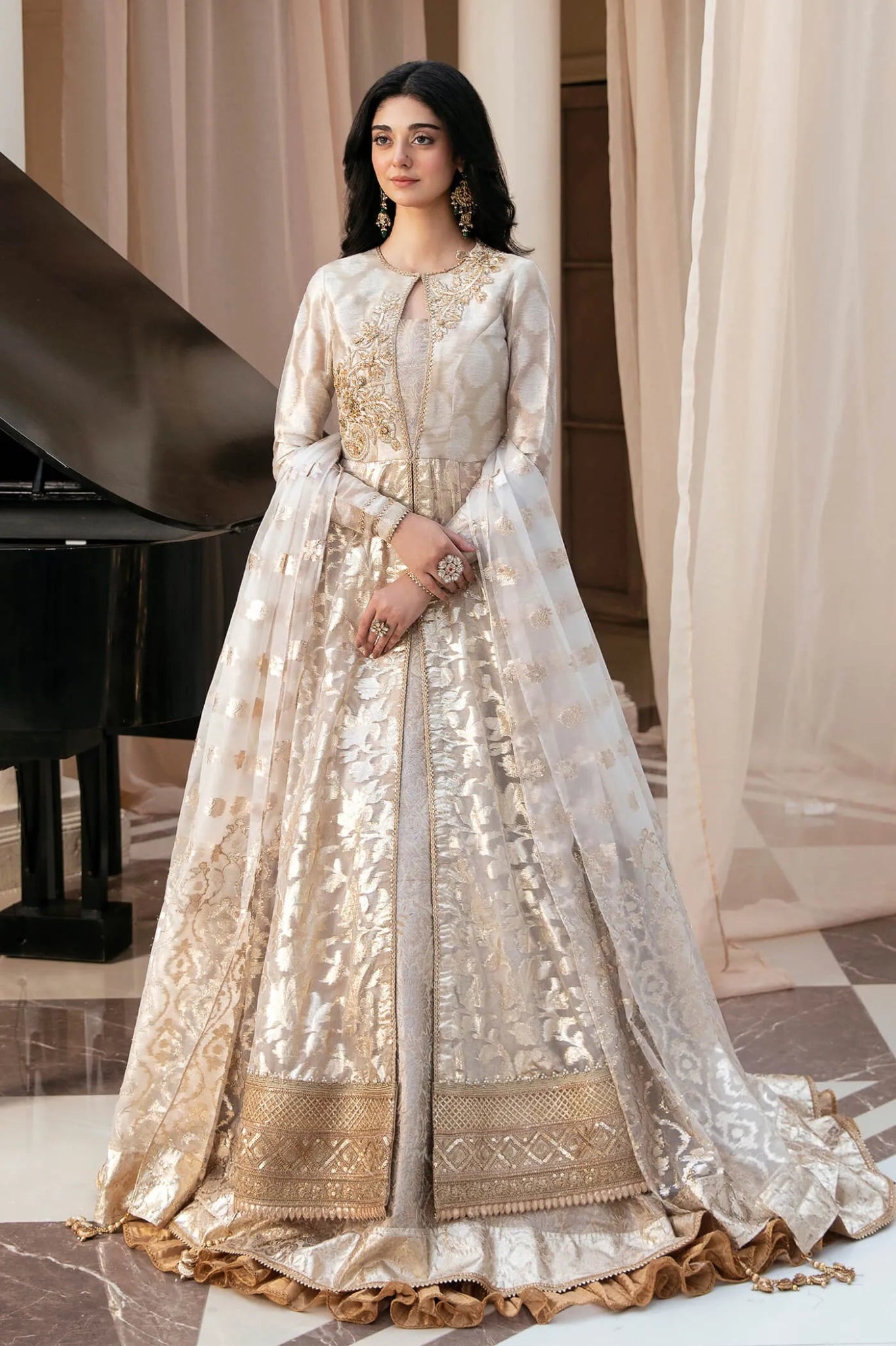Model wearing a luxurious gold and ivory NOOR'S SYMPHONY dress from Musferah Saad's Symphony '23 collection, highlighting Pakistani clothes online in the UK.
