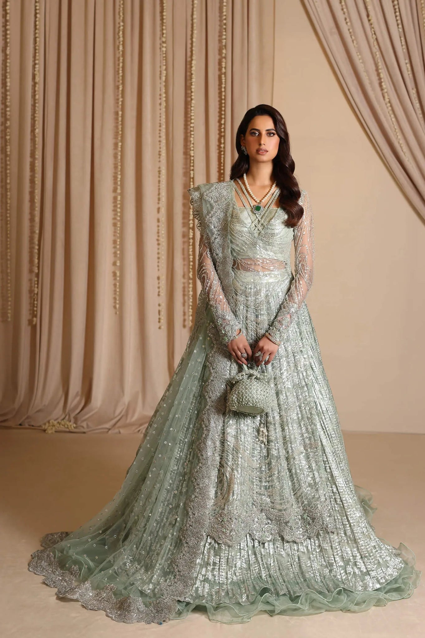 Model wearing Musferah Saad Aqua Grandeur, an exquisite Pakistani bridal dress in UK.