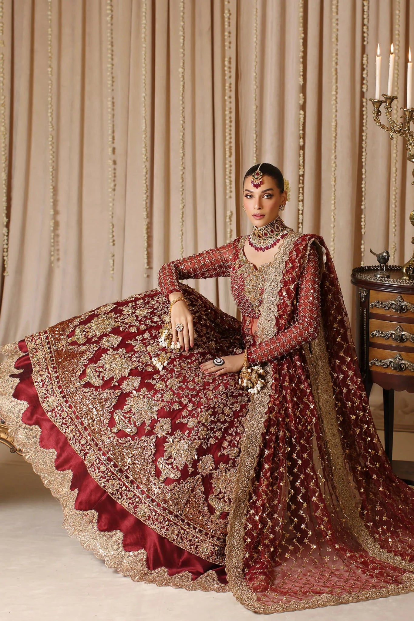 Model wearing a maroon MAHARANI dress from Musferah Saad's The Modern Maharani '23 collection, showcasing Pakistani clothes online in the UK.