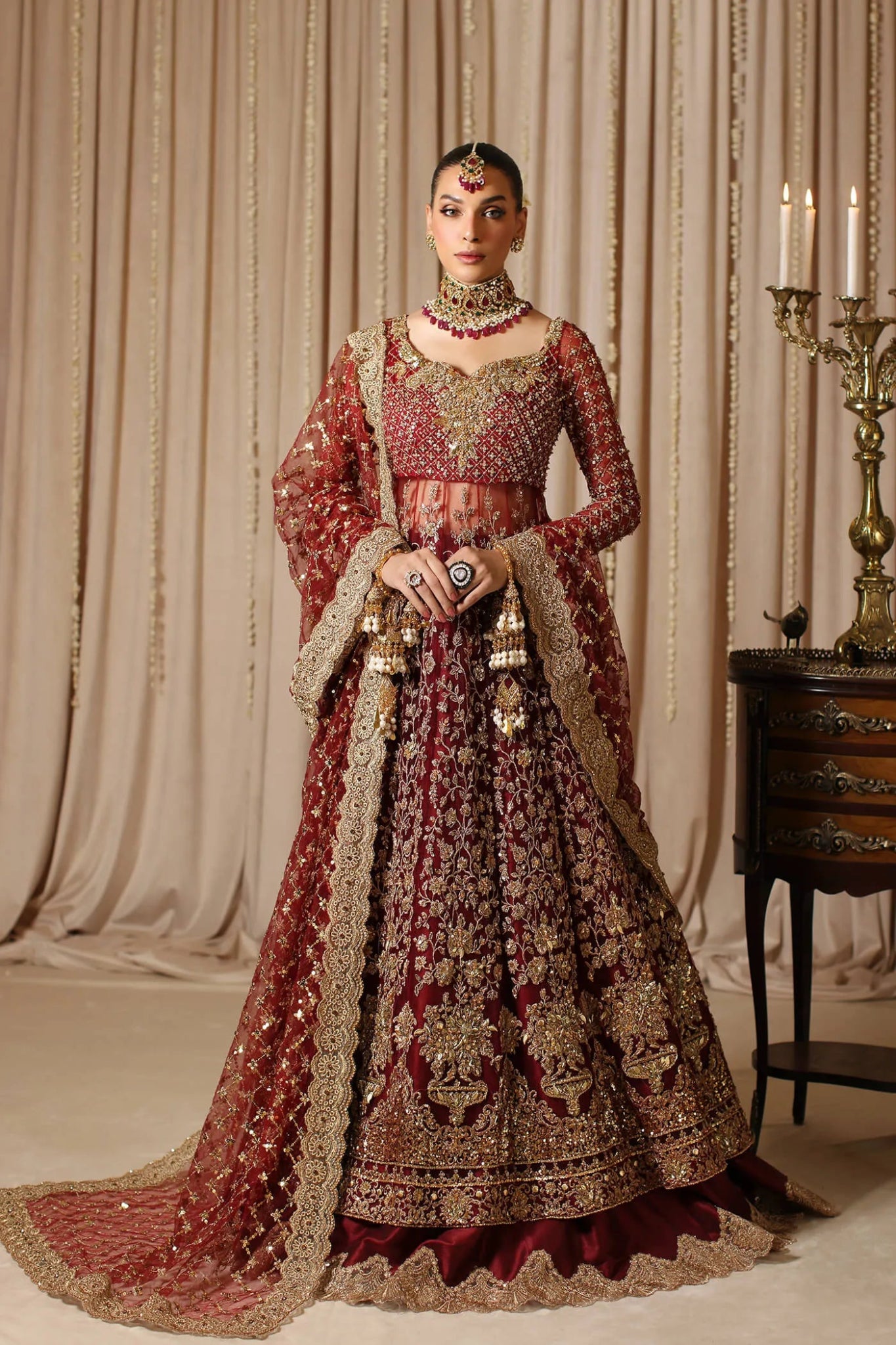 Model wearing a maroon MAHARANI dress from Musferah Saad's The Modern Maharani '23 collection, showcasing Pakistani clothes online in the UK.
