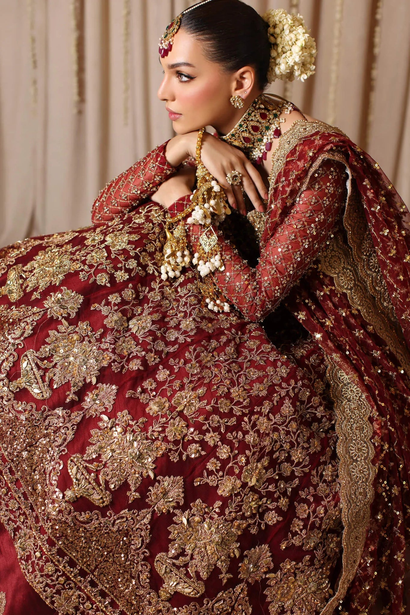 Model wearing a maroon MAHARANI dress from Musferah Saad's The Modern Maharani '23 collection, showcasing Pakistani clothes online in the UK.