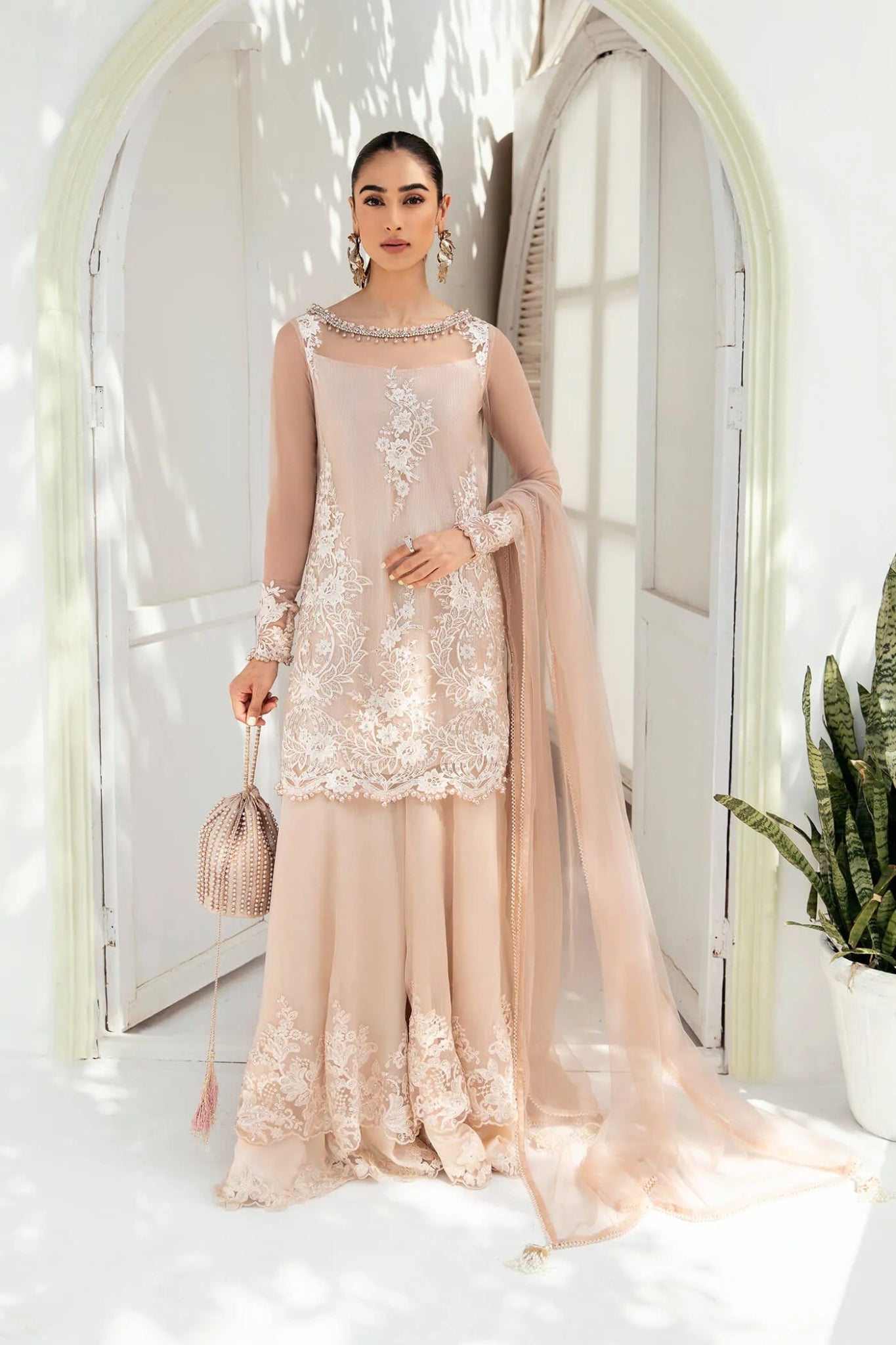 Model wearing VIVA LA VIDA's SUNLIT SERENADE, an equisite mold by Musferah Saad UK, Pakistani Clothes UK.