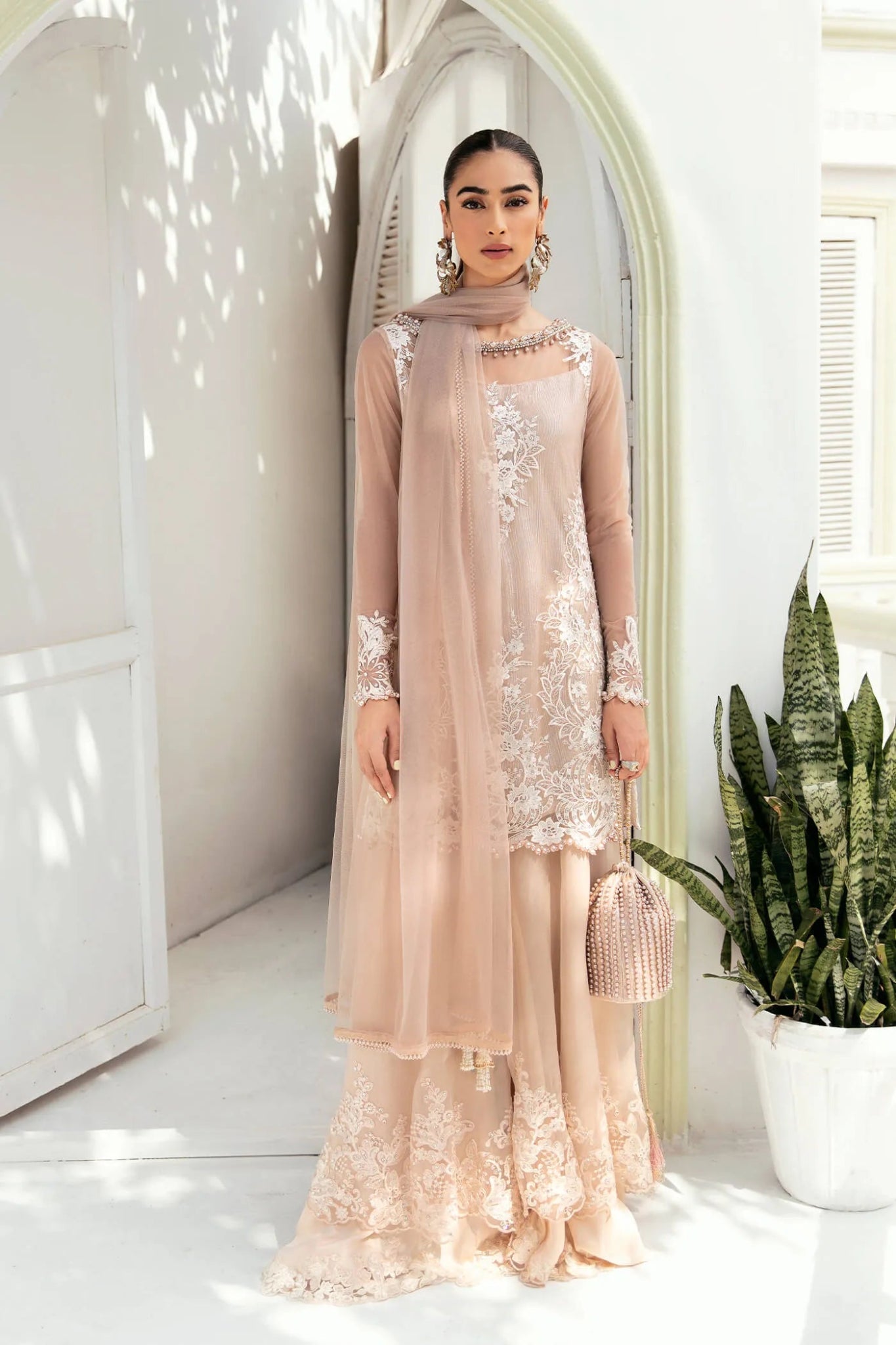 Model wearing a soft beige SUNLIT SERENADE dress from Musferah Saad's VIVA LA VIDA collection, showcasing Pakistani clothes online in the UK.