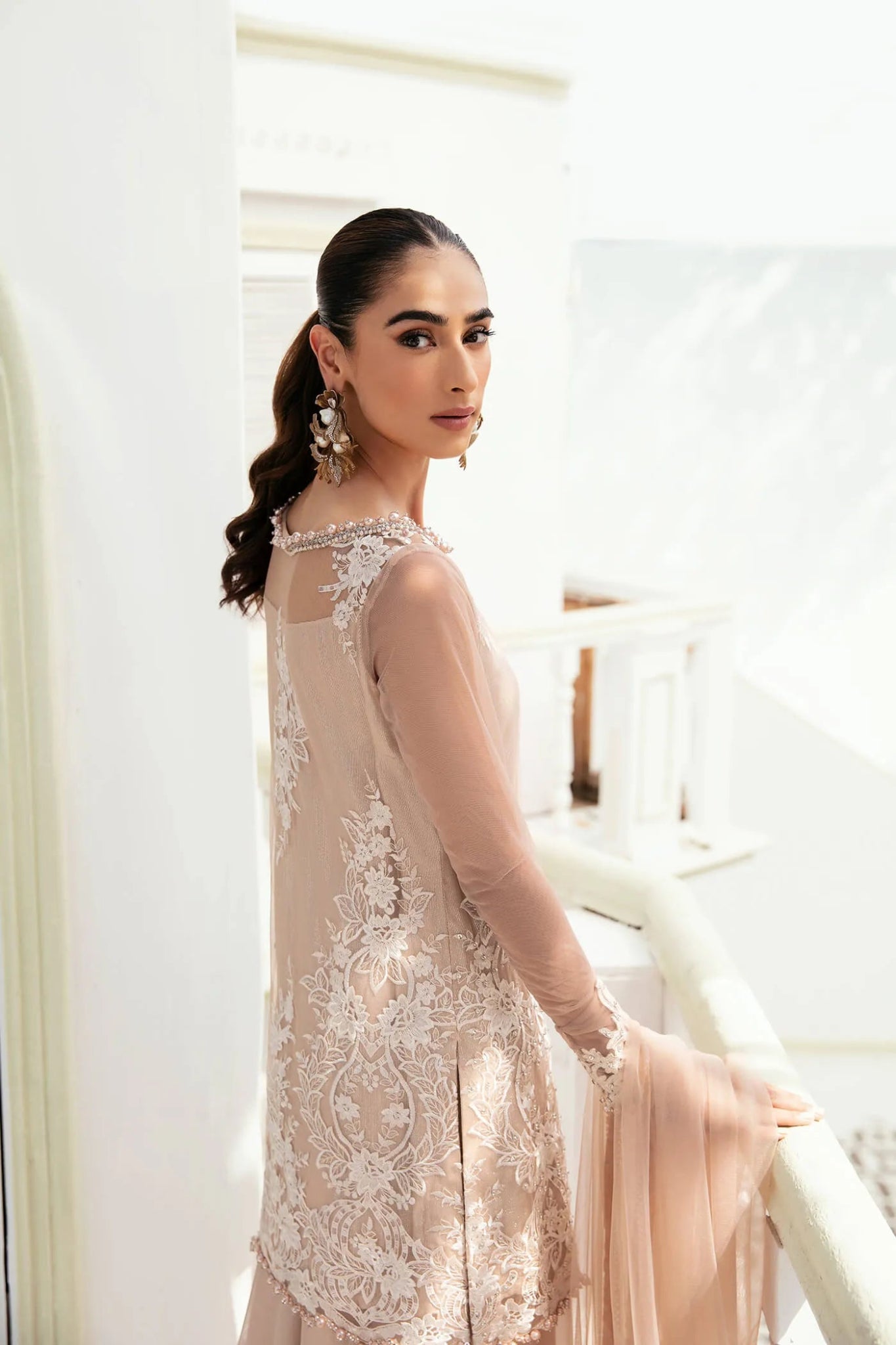 Model wearing a soft beige SUNLIT SERENADE dress from Musferah Saad's VIVA LA VIDA collection, showcasing Pakistani clothes online in the UK.