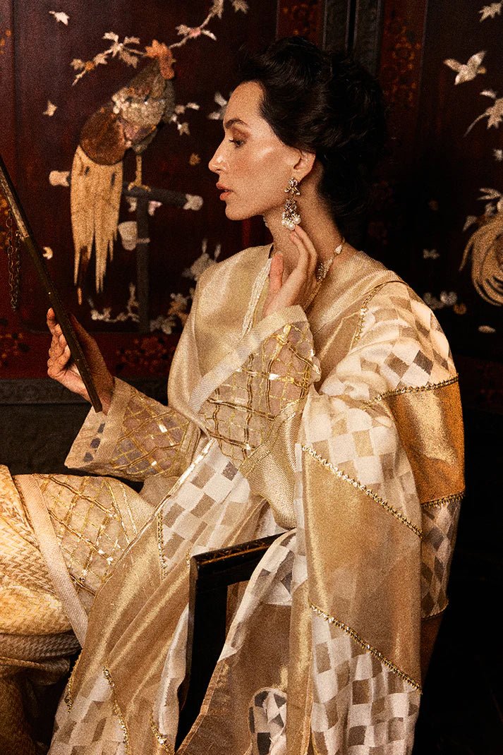 Model wearing a golden Basanti outfit from Mushq with intricate gota detailing, showcasing Pakistani designer clothes online in the UK, perfect for weddings.