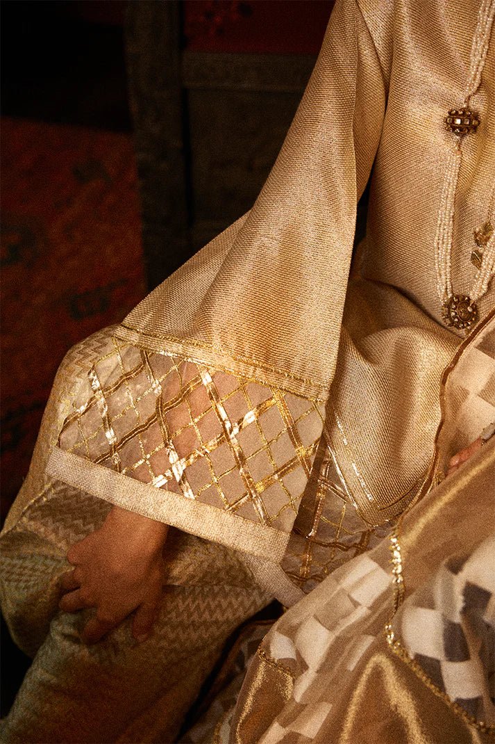 Model wearing a golden Basanti outfit from Mushq with intricate gota detailing, showcasing Pakistani designer clothes online in the UK, perfect for weddings.
