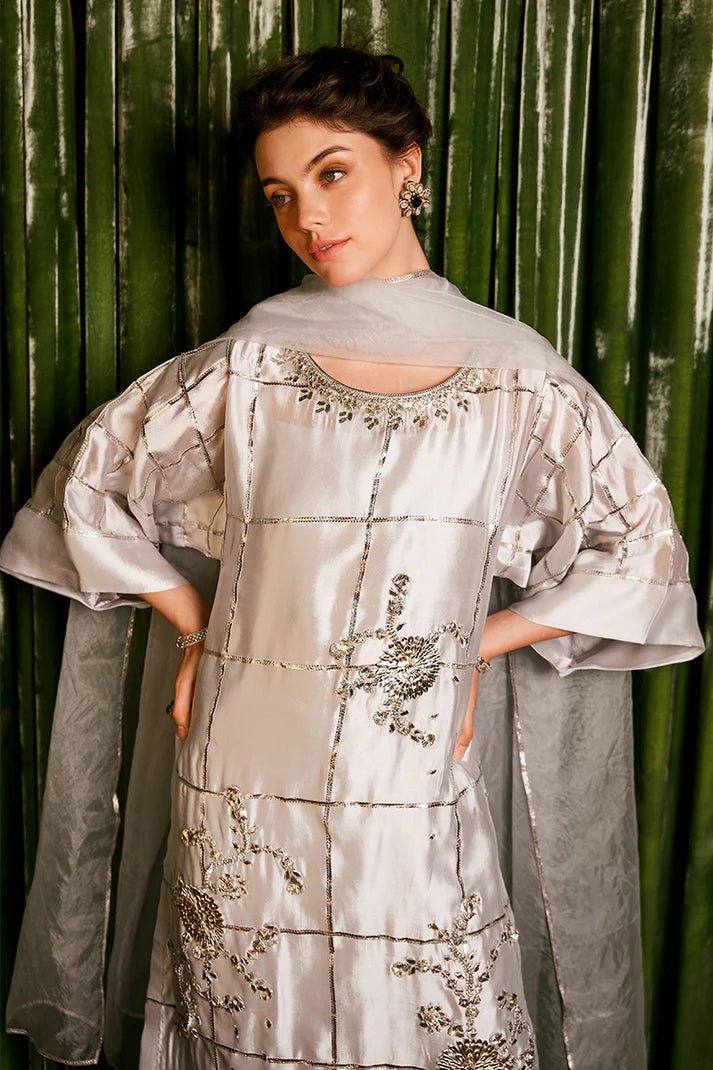 Model wearing a stunning silver Chambeeli outfit from Mushq featuring delicate gota embellishments, perfect for Pakistani weddings, available online in the UK.