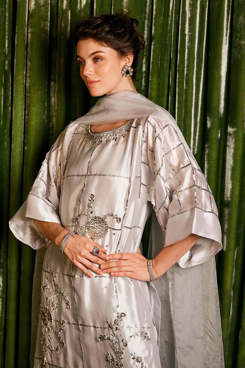 Model wearing a stunning silver Chambeeli outfit from Mushq featuring delicate gota embellishments, perfect for Pakistani weddings, available online in the UK.