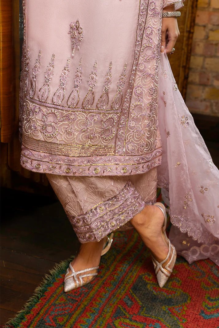 Model wearing Nadine from Mushq's Espoir Luxury Pret '24 in vibrant coral, showcasing luxury Pakistani clothes online in UK.