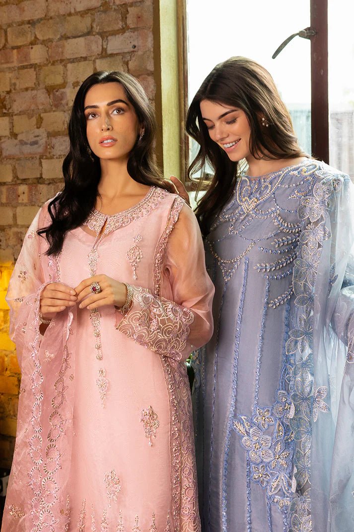 Model wearing Nadine from Mushq's Espoir Luxury Pret '24 in vibrant coral, showcasing luxury Pakistani clothes online in UK.