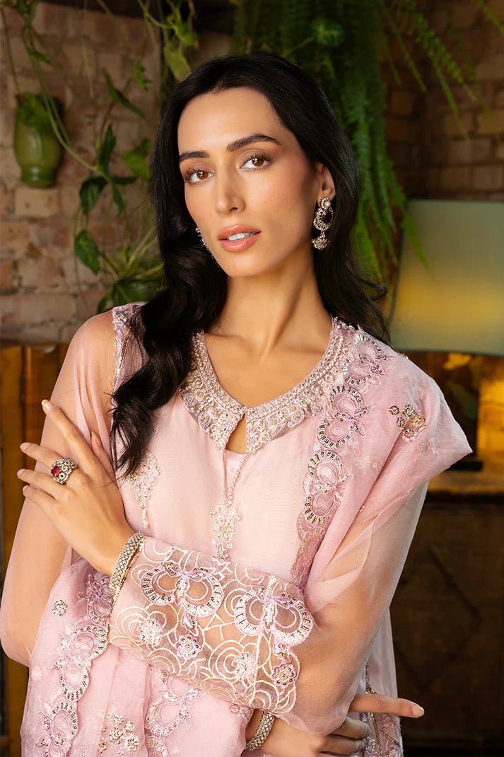 Model wearing Nadine from Mushq's Espoir Luxury Pret '24 in vibrant coral, showcasing luxury Pakistani clothes online in UK.