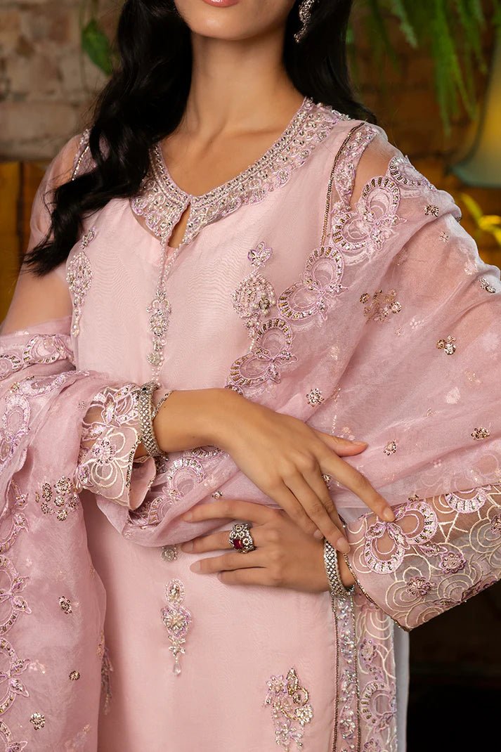 Model wearing Nadine from Mushq's Espoir Luxury Pret '24 in vibrant coral, showcasing luxury Pakistani clothes online in UK.