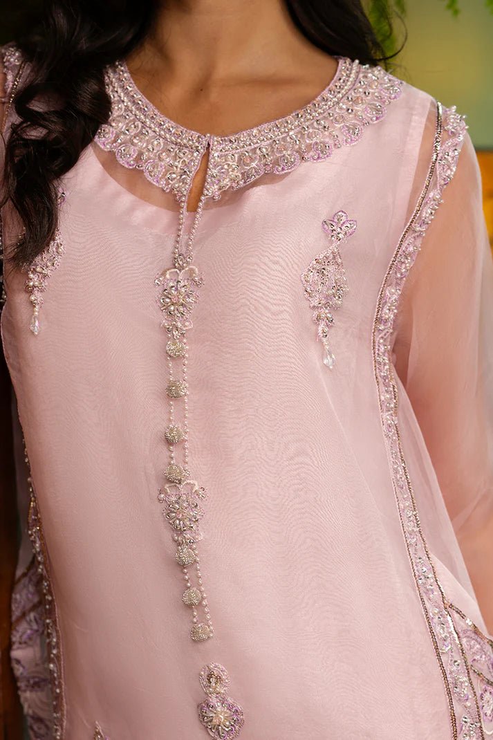 Model wearing Nadine from Mushq's Espoir Luxury Pret '24 in vibrant coral, showcasing luxury Pakistani clothes online in UK.