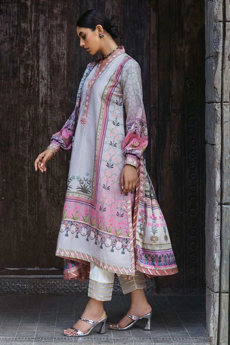 Model wearing Pewter dress from Mushq's Nirvana Silk Edit, featuring intricate floral prints in shades of pewter, pink, and grey. Pakistani winter casual pret clothes available online in the UK.
