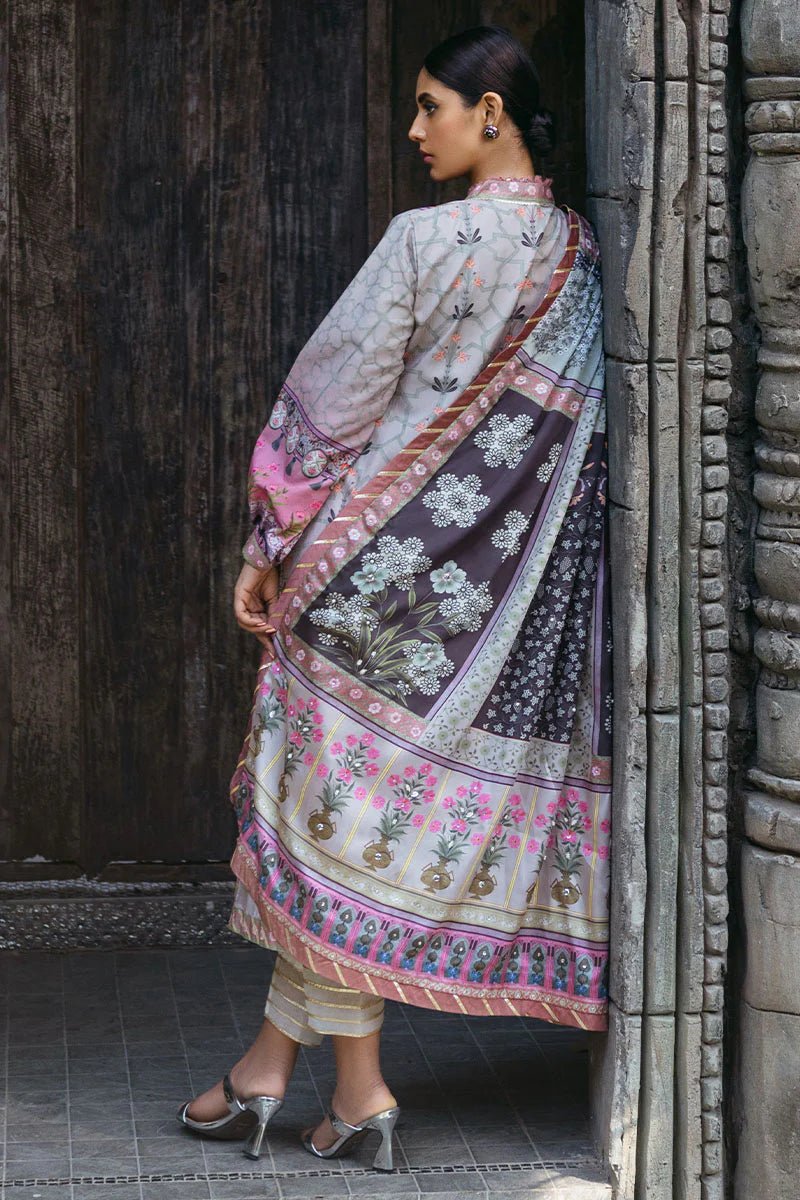 Model wearing Pewter dress from Mushq's Nirvana Silk Edit, featuring intricate floral prints in shades of pewter, pink, and grey. Pakistani winter casual pret clothes available online in the UK.